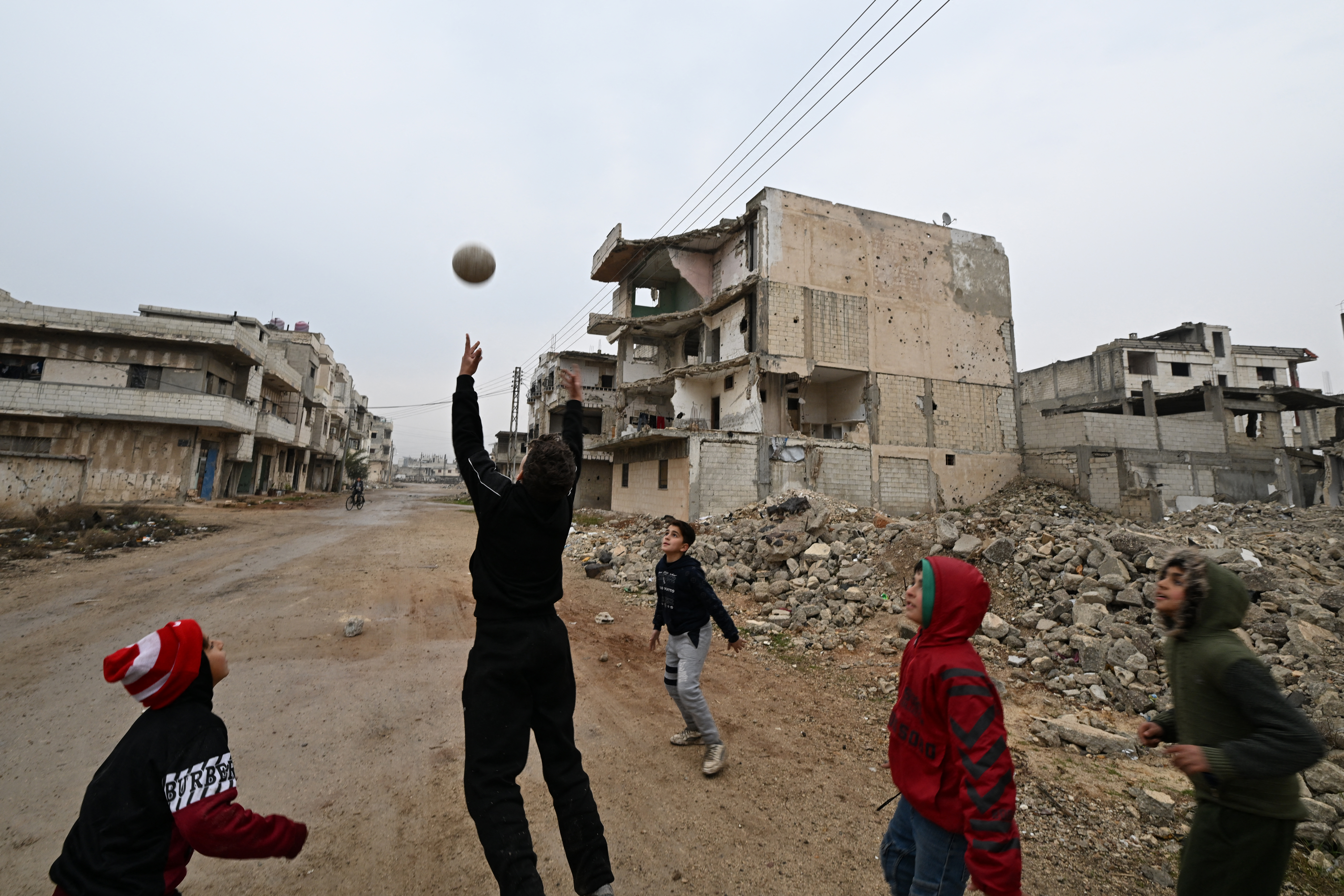 Syrian children play in the heavily damaged Baba Amr neighbourhood following the return of their families to the central Syrian city of Homs