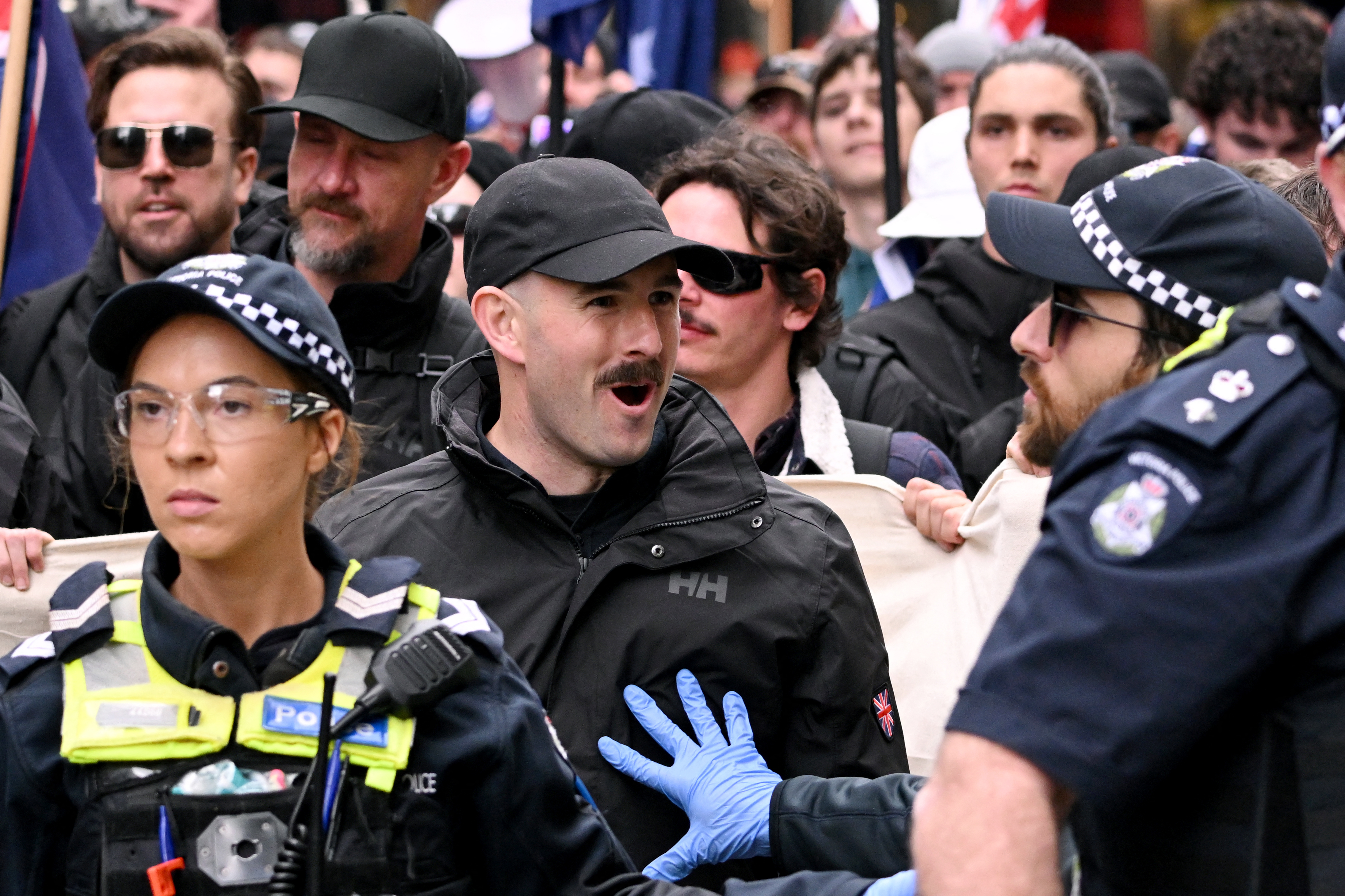 National Socialist Network member Thomas Sewell (C) reacts against a police officer during a "March for Australia" anti-immigration rally in Melbourne on August 31, 2025. (Photo by William WEST / AFP)