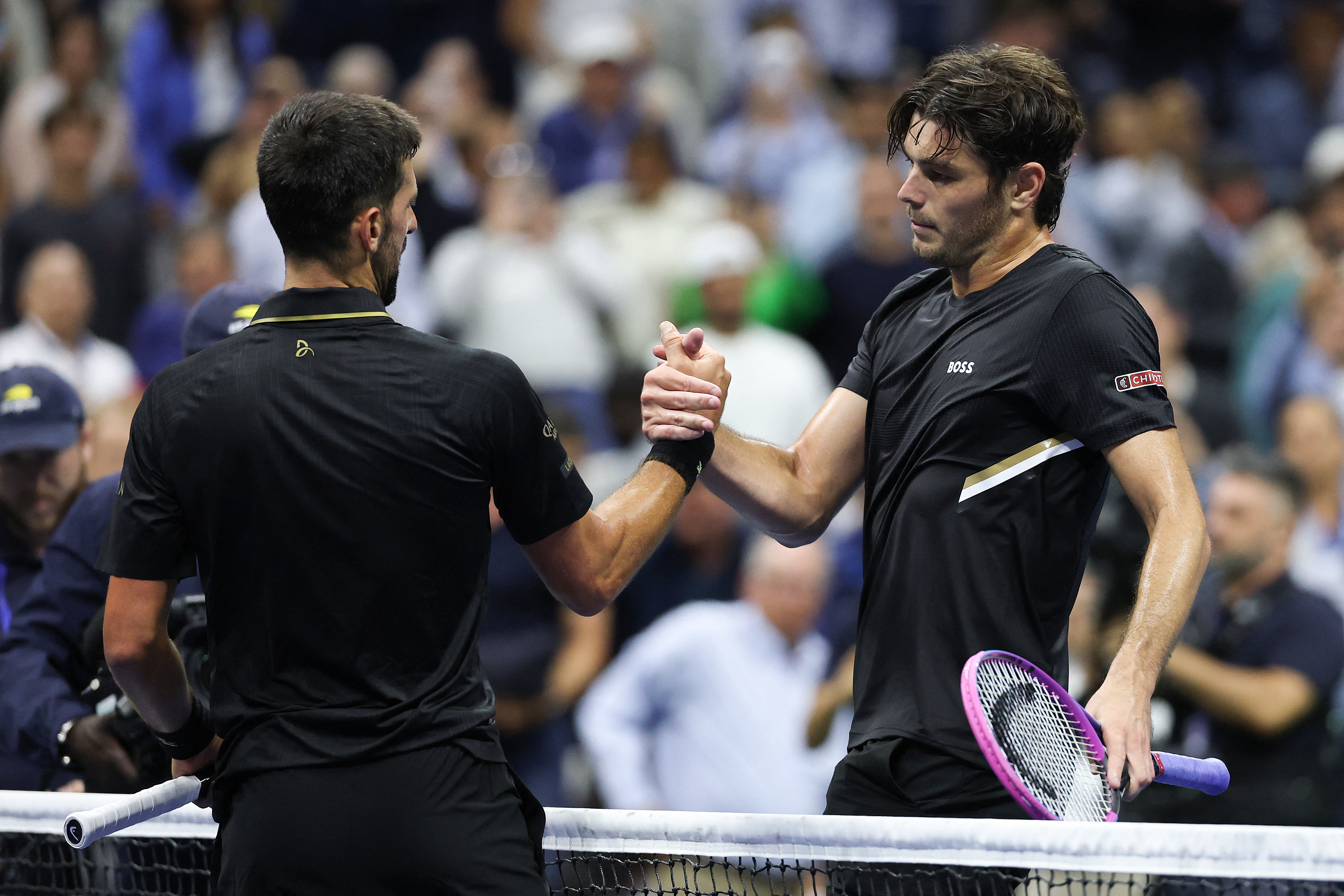 Djokovic and Fritz shake hands.