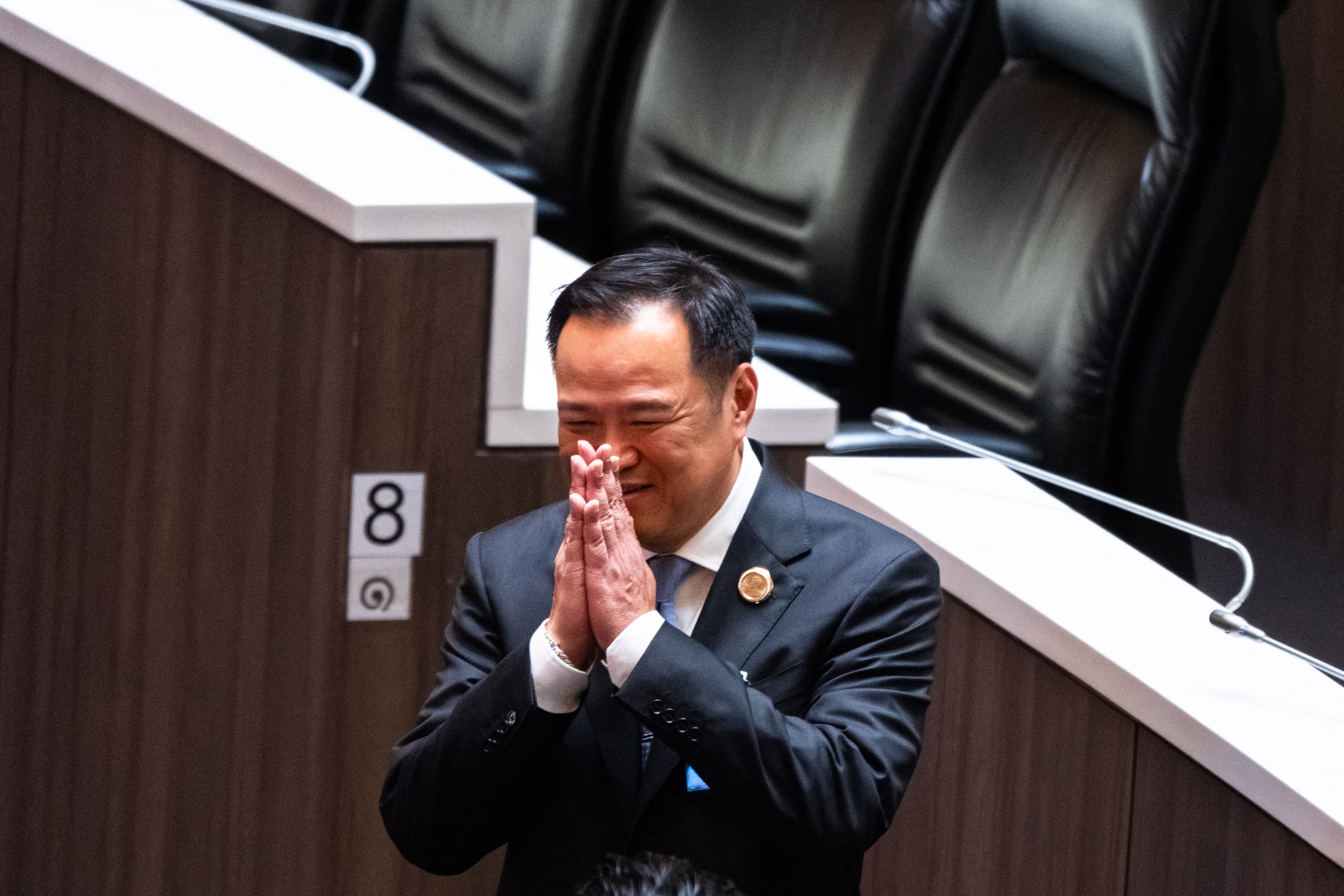 Bhumjaithai Party leader Anutin Charnvirakul gestures in the parliament chamber.