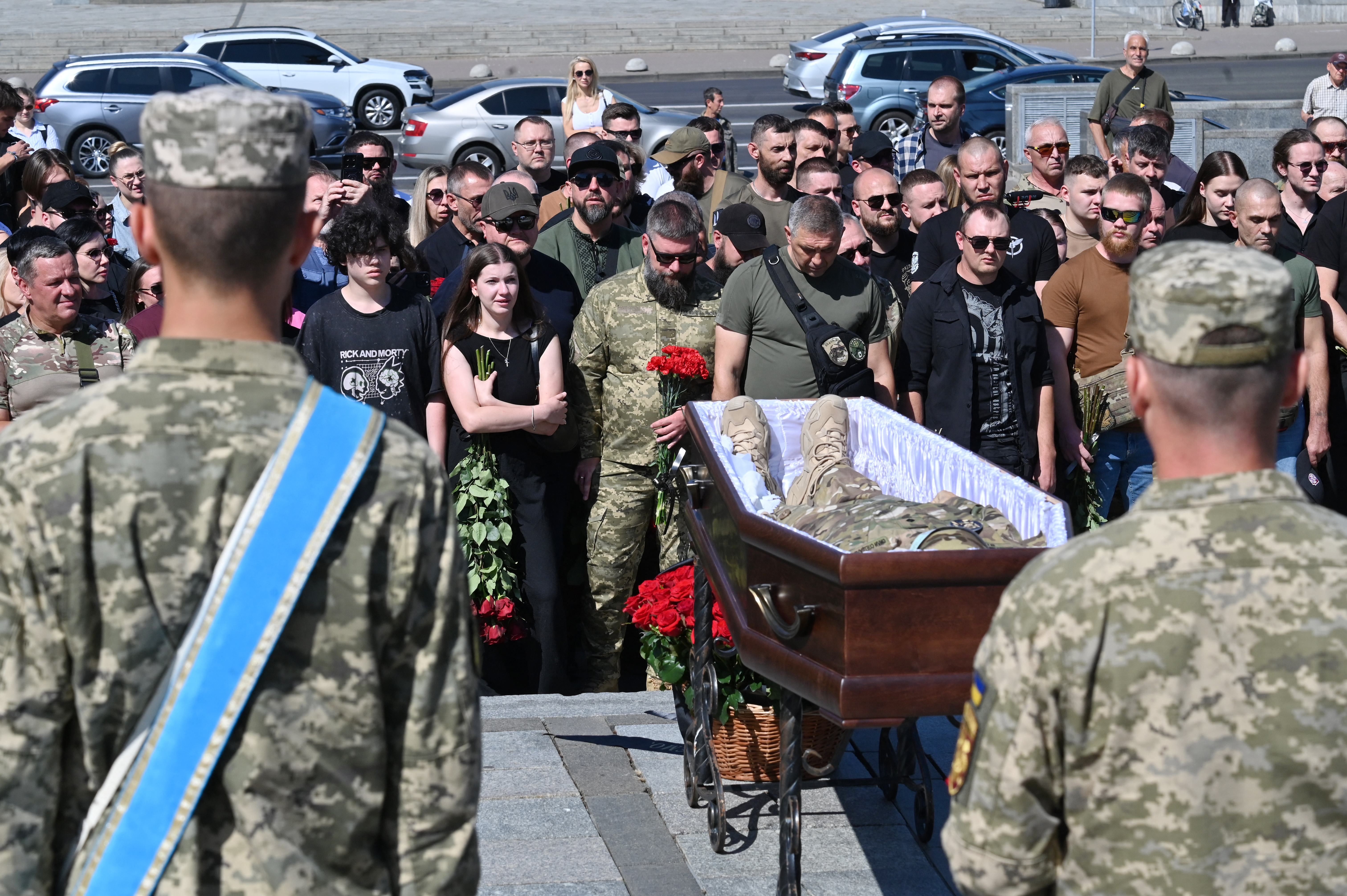Brothers in arms and relatives stand in front of the coffin of Vitali Panakhov, the Ukrainian serviceman with сall sign "Witch", during his funeral ceremony at Independence Square in Kyiv on September 5, 2025, amid the Russian invasion of Ukraine. (Photo by Sergei SUPINSKY / AFP)