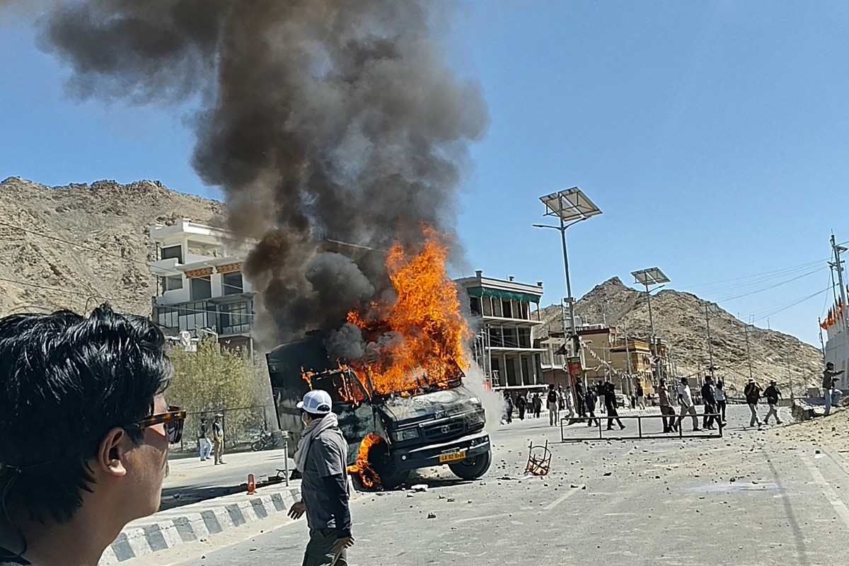A police vehicle torched by demonstrators is pictured along a street near the Bharatiya Janata Party office in Leh, on September 24, 2025 [Tsewang Rizgin/AFP]