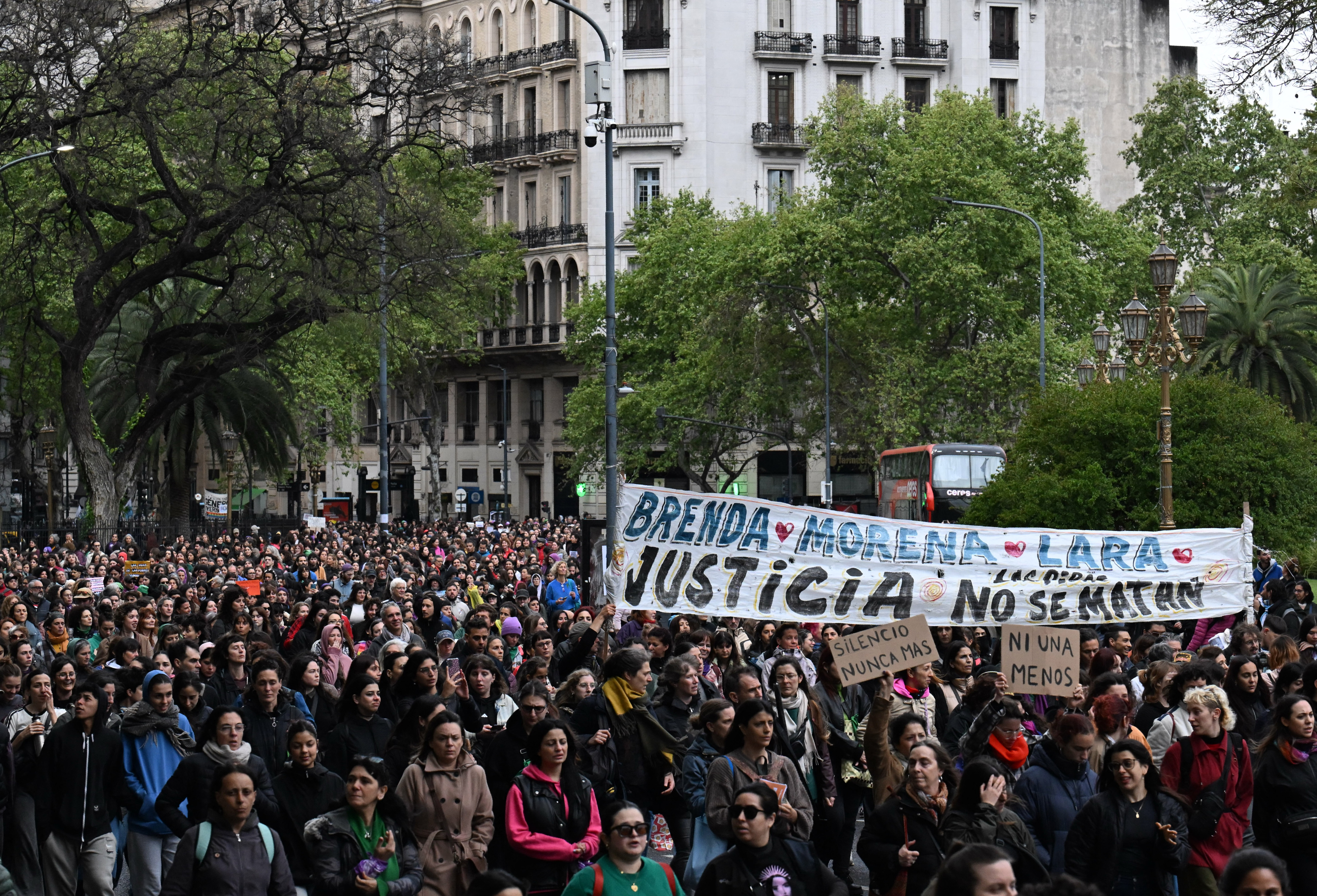 Relatives and friends attend a demonstration called by rights groups under the banner: "There are no good or bad victims, only femicides," referencing the three murdered teenagers' alleged involvment in sex work, in Buenos Aires, on September 27, 2025. The bodies of Morena Verdi and Brenda Del Castillo, cousins aged 20, and 15-year-old Lara Gutierrez were found buried last September 24 in the yard of a house, five days after they went missing. The crime, which investigators have tied to narco activity, was perpetrated live on Instagram and watched by 45 members of a private account, officials said. (Photo by Luis ROBAYO / AFP)