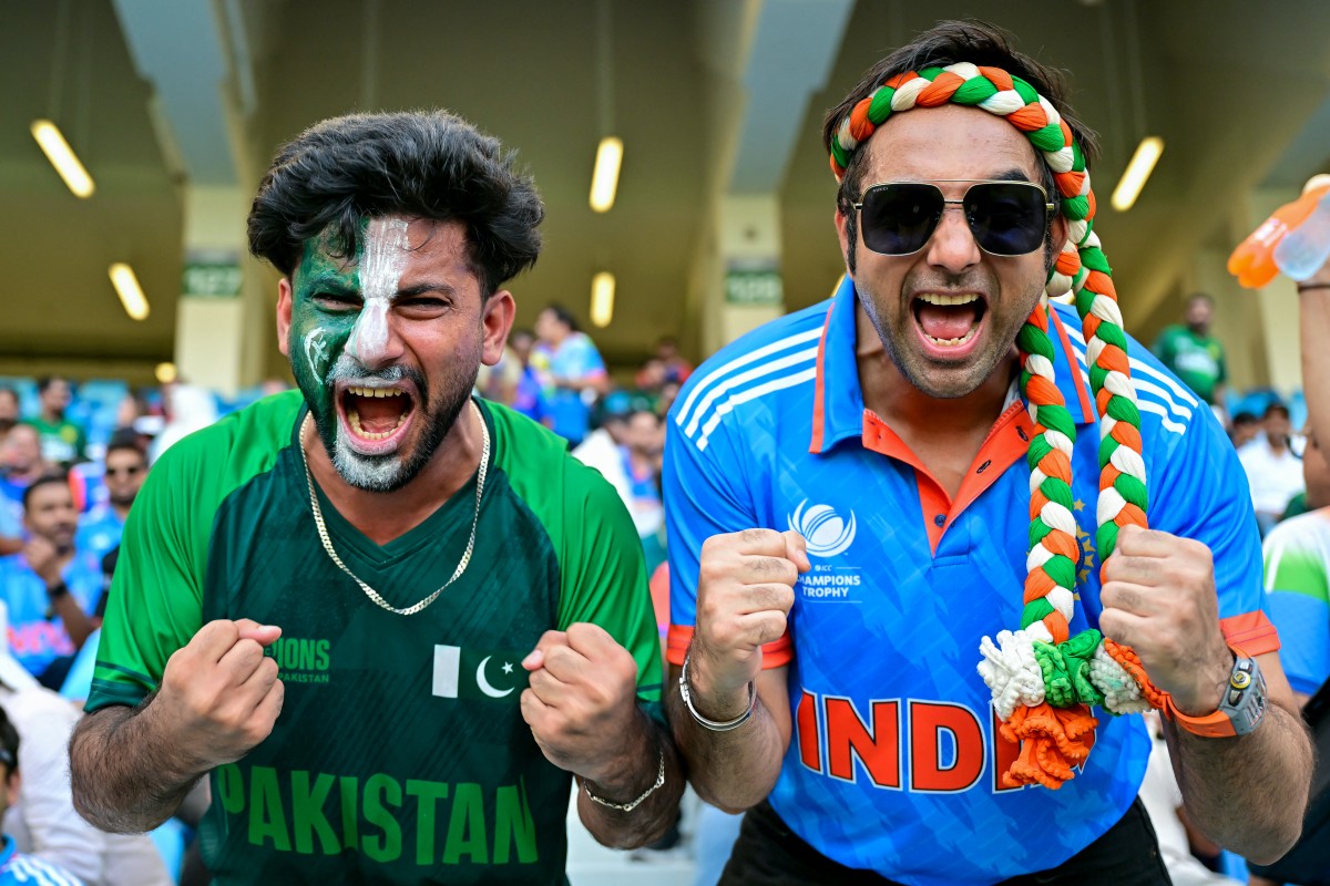 A Pakistani and an Indian fan pose for a photo before the start of the Asia Cup