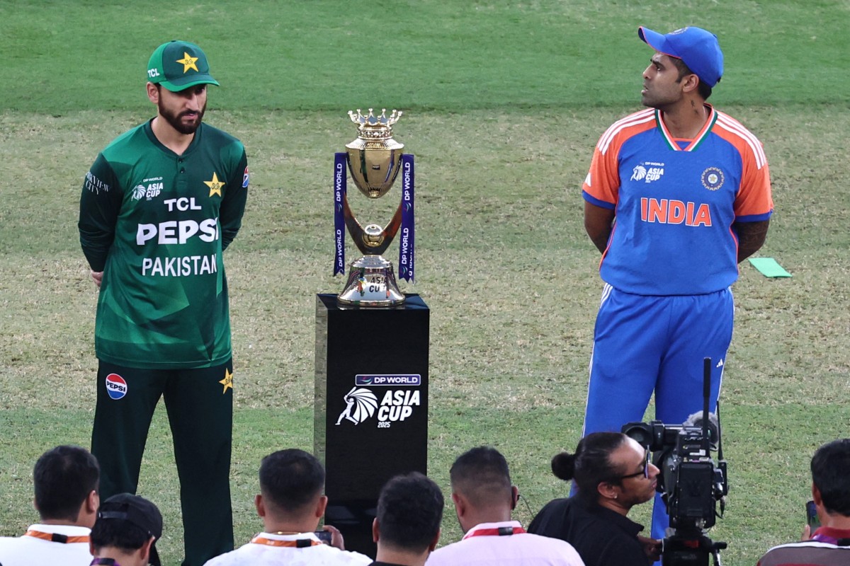 India's captain Suryakumar Yadav (R) and his Pakistani counterpart Salman Agha stand on the field for the toss before the start of the Asia Cup 2025 Twenty20 international cricket final match between India and Pakistan at the Dubai International Stadium in Dubai on September 28, 2025. (Photo by Fadel SENNA / AFP)
