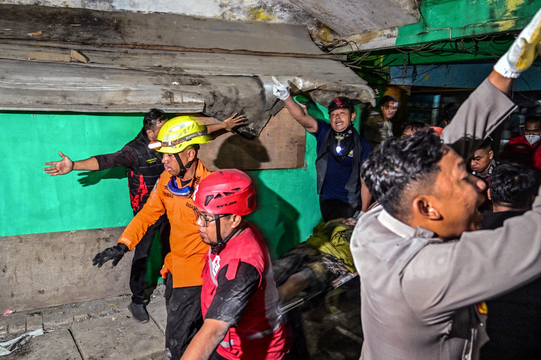 Rescue personnel carry an injured student.