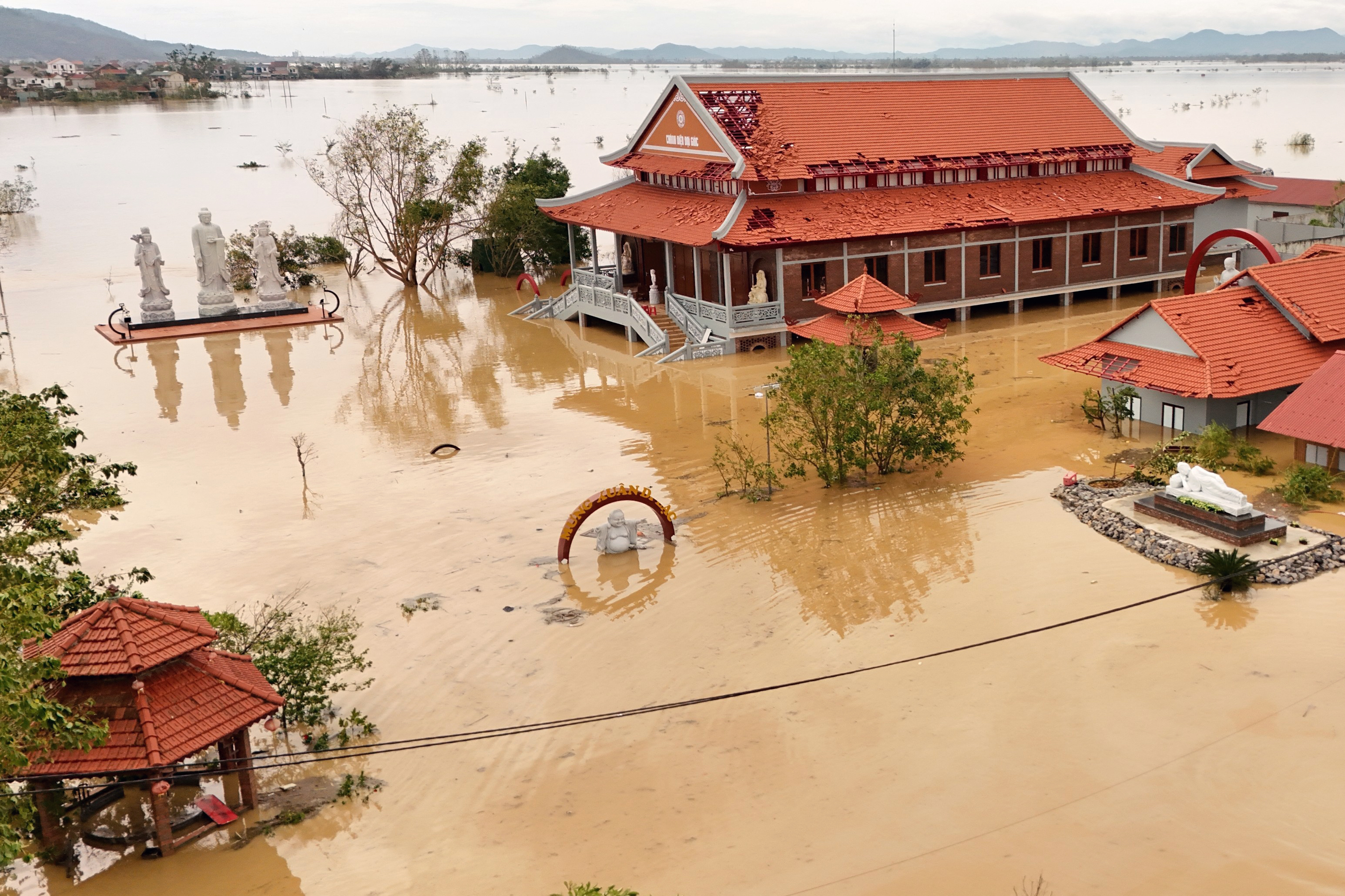 Floodwaters surrounding a pagoda complex.