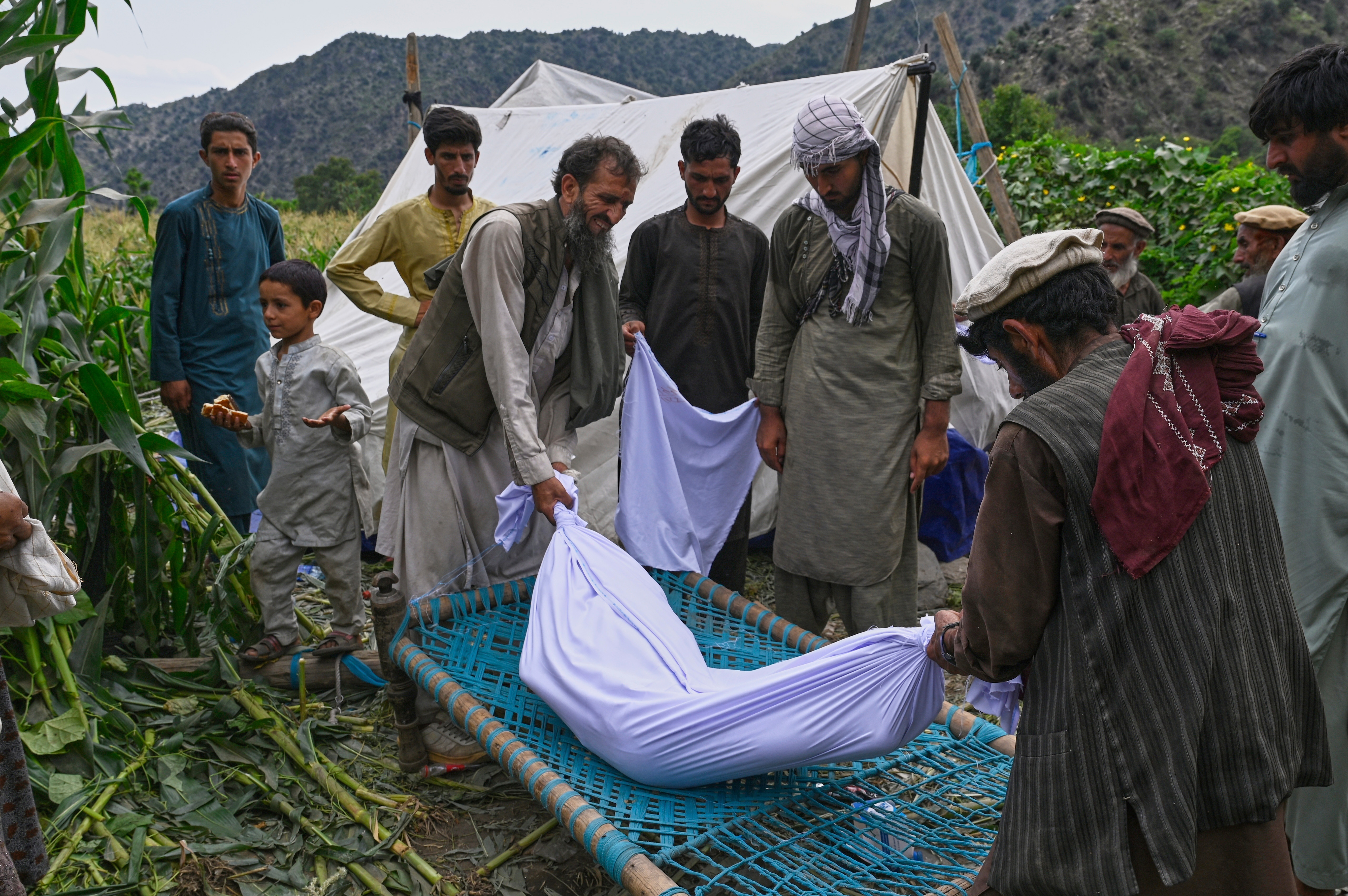 The body of a girl is placed on a bed frame after being pulled from the rubble following Sunday night's powerful 6.0-magnitude earthquake, in a remote area of Kunar province, Afghanistan, Tuesday, Sept. 2, 2025. [Nava Jamshidi/AP Photo] (AP Photo)