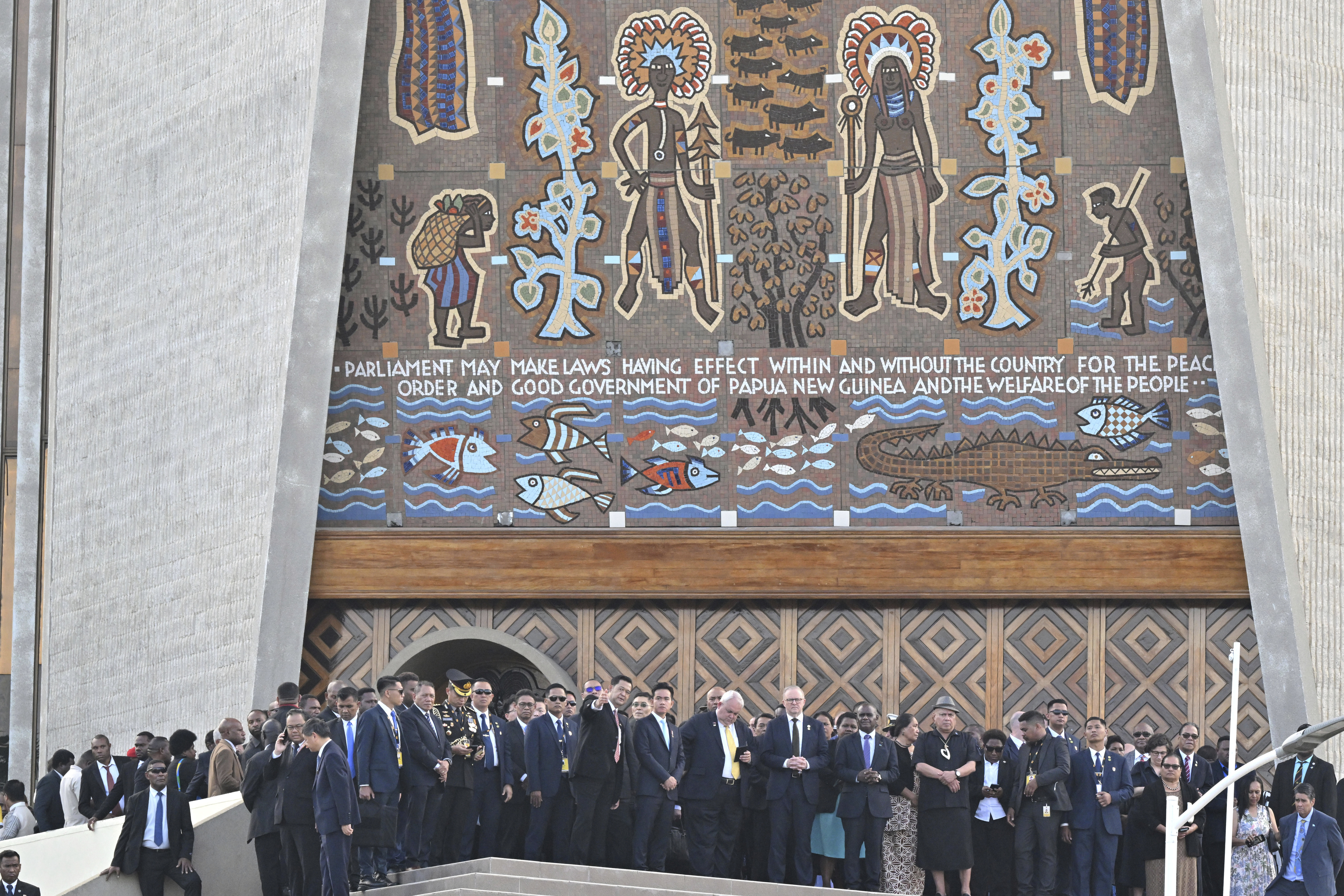 Australian Prime Minister Anthony Albanese, center right, and other dignitaries stand in front of Parliament House after a flag raising ceremony in Port Moresb