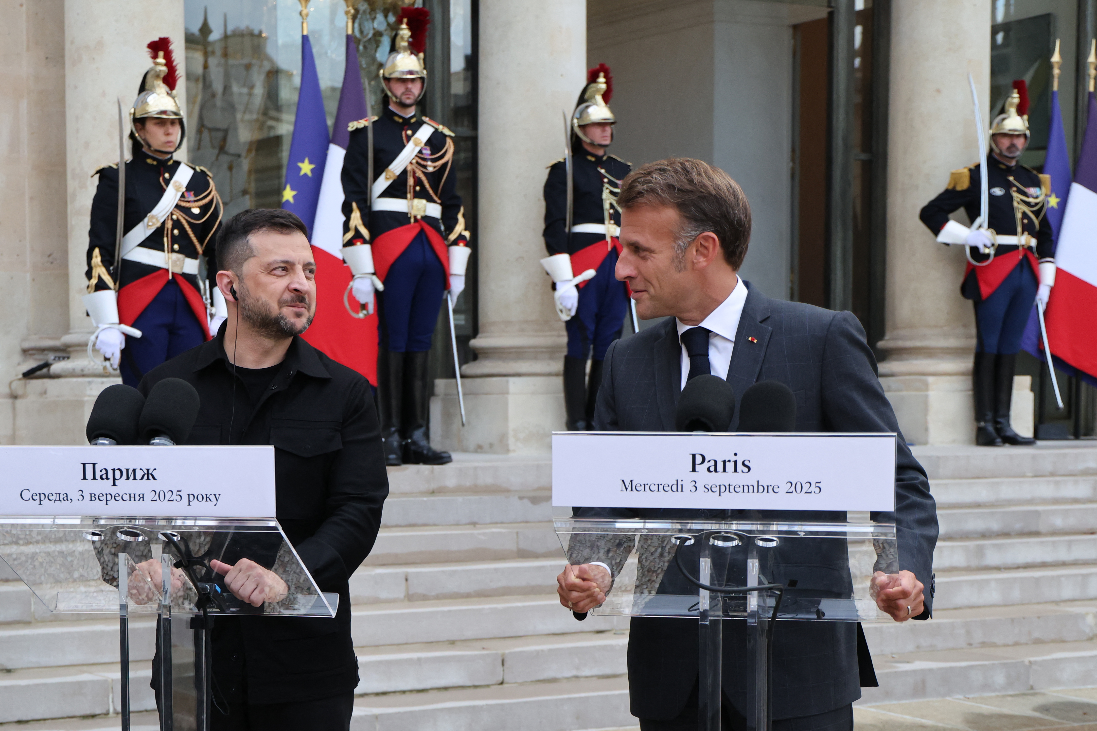 Ukraine's President Volodymyr Zelensky (L) and France's President Emmanuel Macron speak prior to their meeting, at The Elysee Presidential Palace in Paris on September 3, 2025.