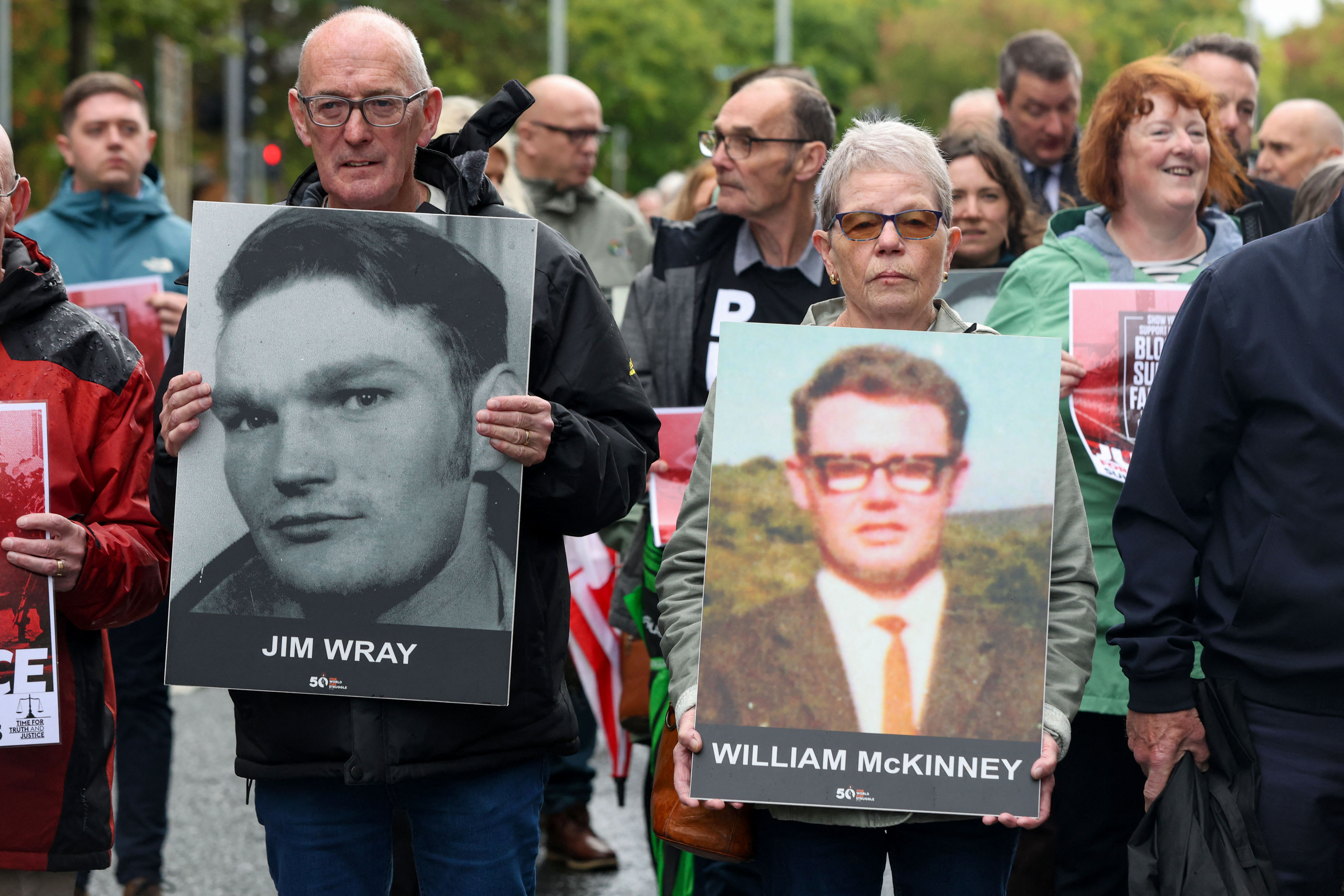 Family members carry photographs of those killed on Bloody Sunday as they walk to Belfast crown court as the trial of soldier F begins, in Belfast, Northern Ireland on September 15, 2025.