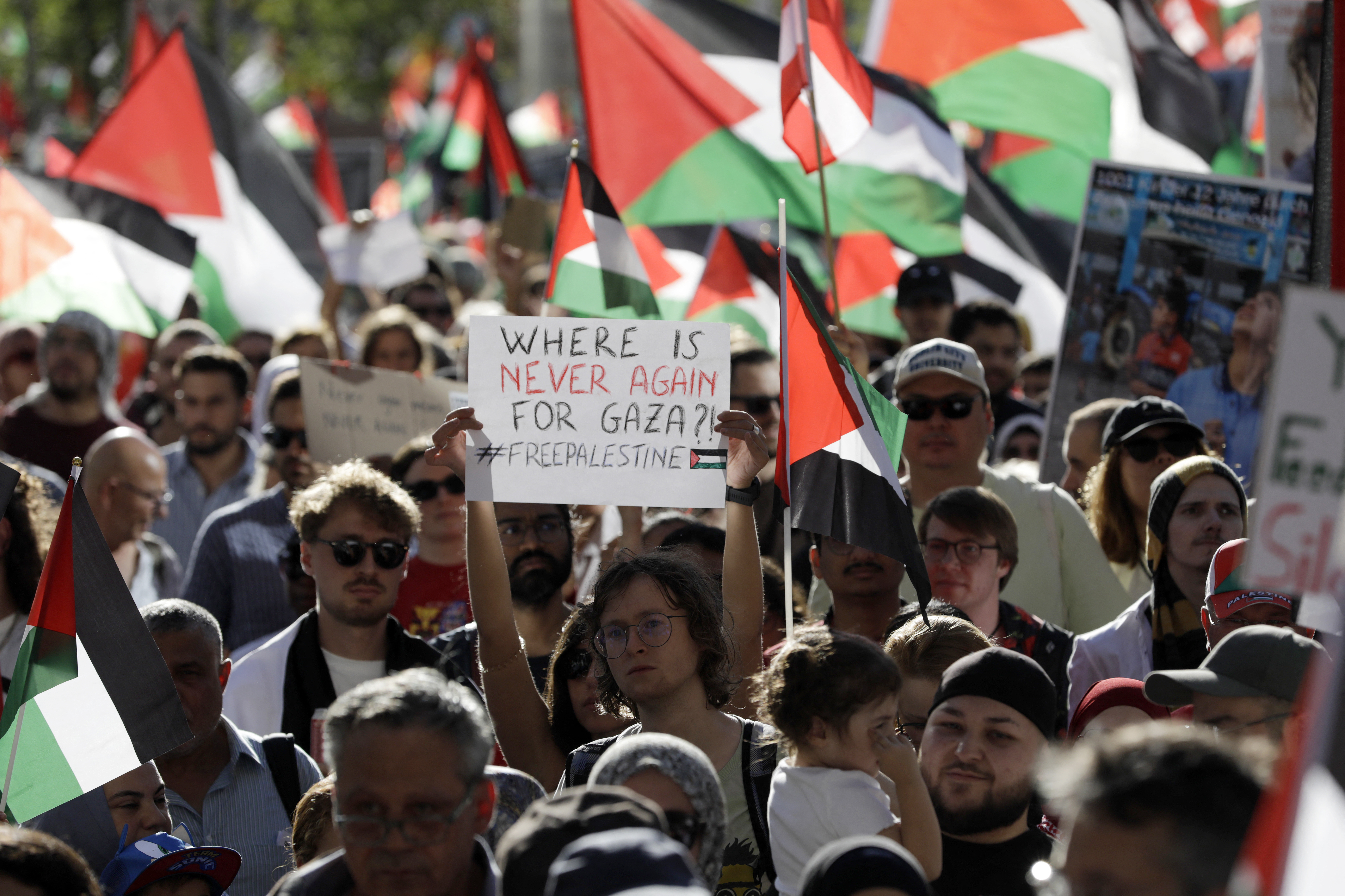 A participant displays a placard reading 'Where is never again for Gaza?' during a demonstration under the slogan 'Sanctions against Israel - Stop the genocide and starvation now! - Solidarity with Palestine' in Vienna on September 20, 2025.
