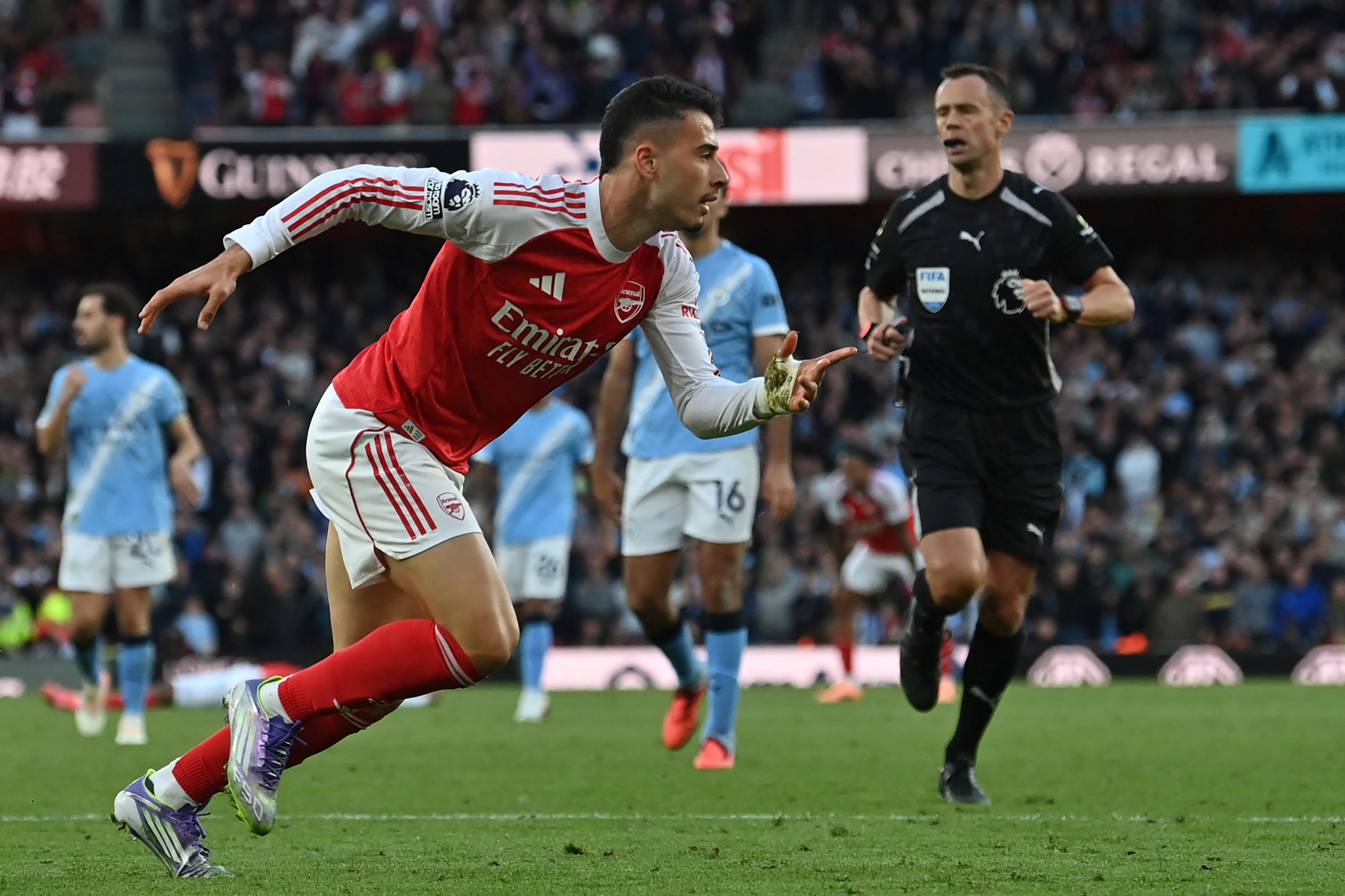 Arsenal's Brazilian midfielder #11 Gabriel Martinelli celebrates after scoring their first goal during the English Premier League football match between Arsenal and Manchester City at the Emirates Stadium in London on September 21, 2025.