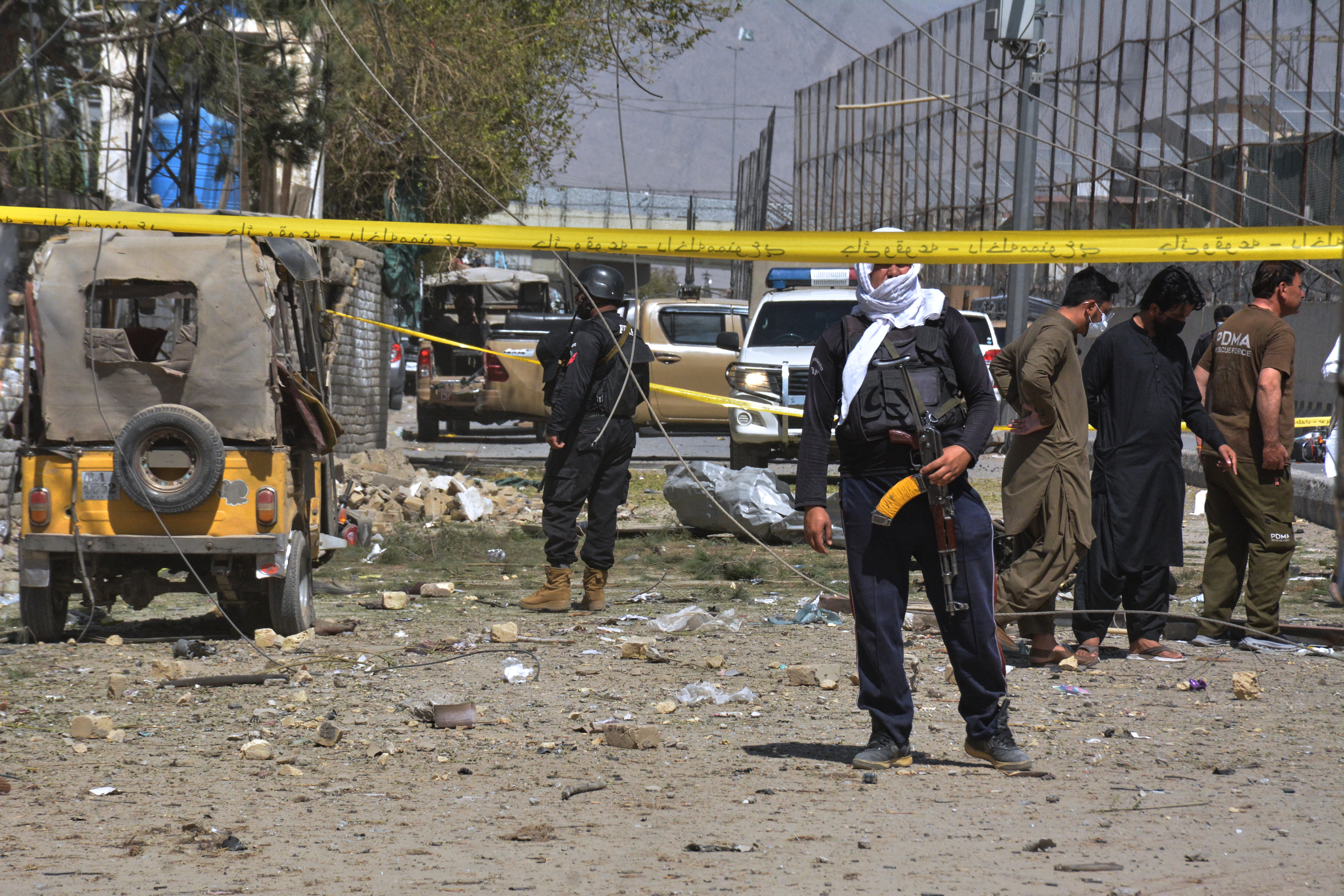 Security officials examine damaged vehicles at the site of a powerful car bombing, in Quetta, Pakistan, Tuesday, Sept. 30, 2025. (AP Photo/Arshad Butt)