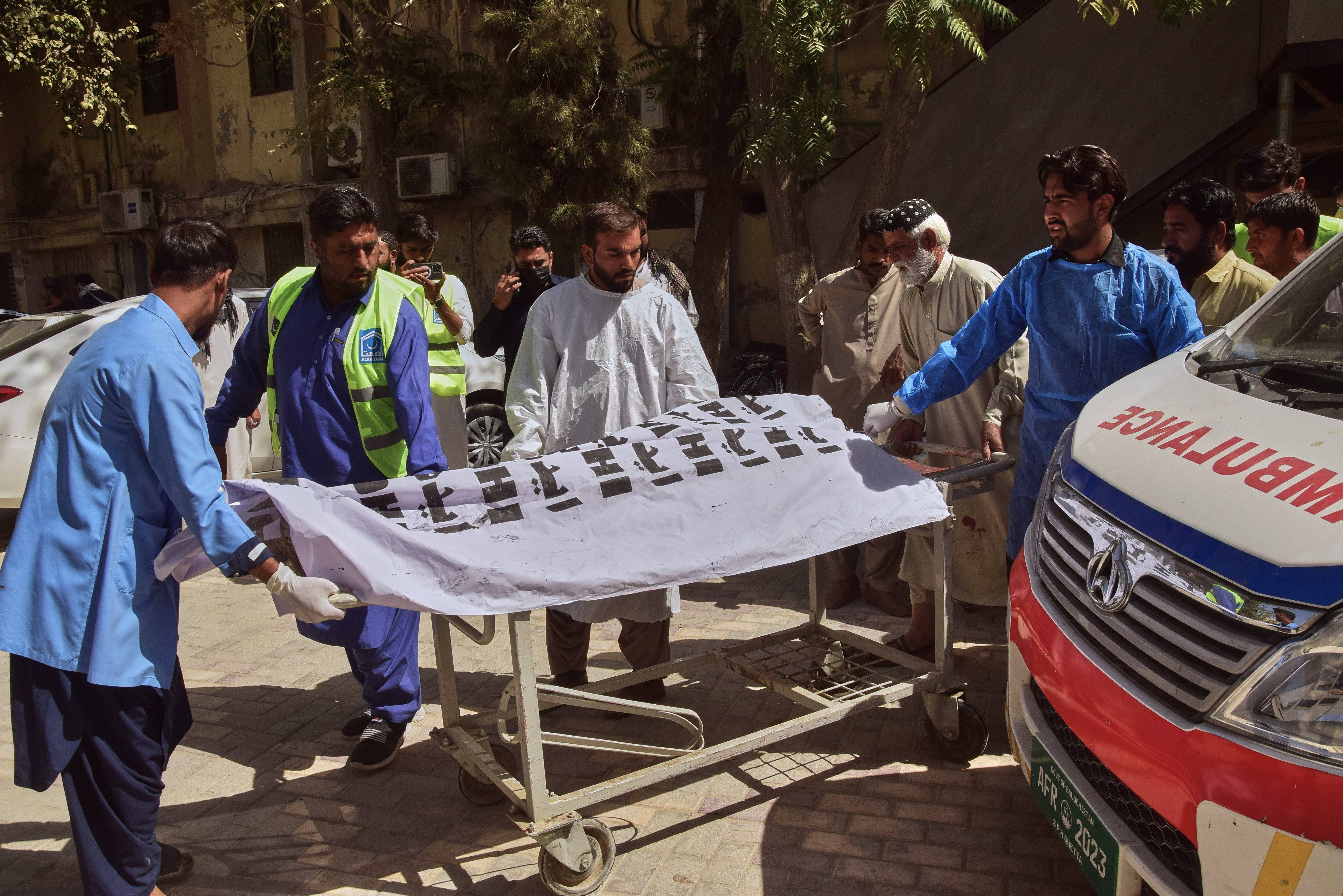 Rescue workers and volunteers transport the dead body of a victim of a powerful car bombing upon arrival at a hospital, in Quetta, Pakistan, Tuesday, Sept. 30, 2025. (AP Photo/Arshad Butt)