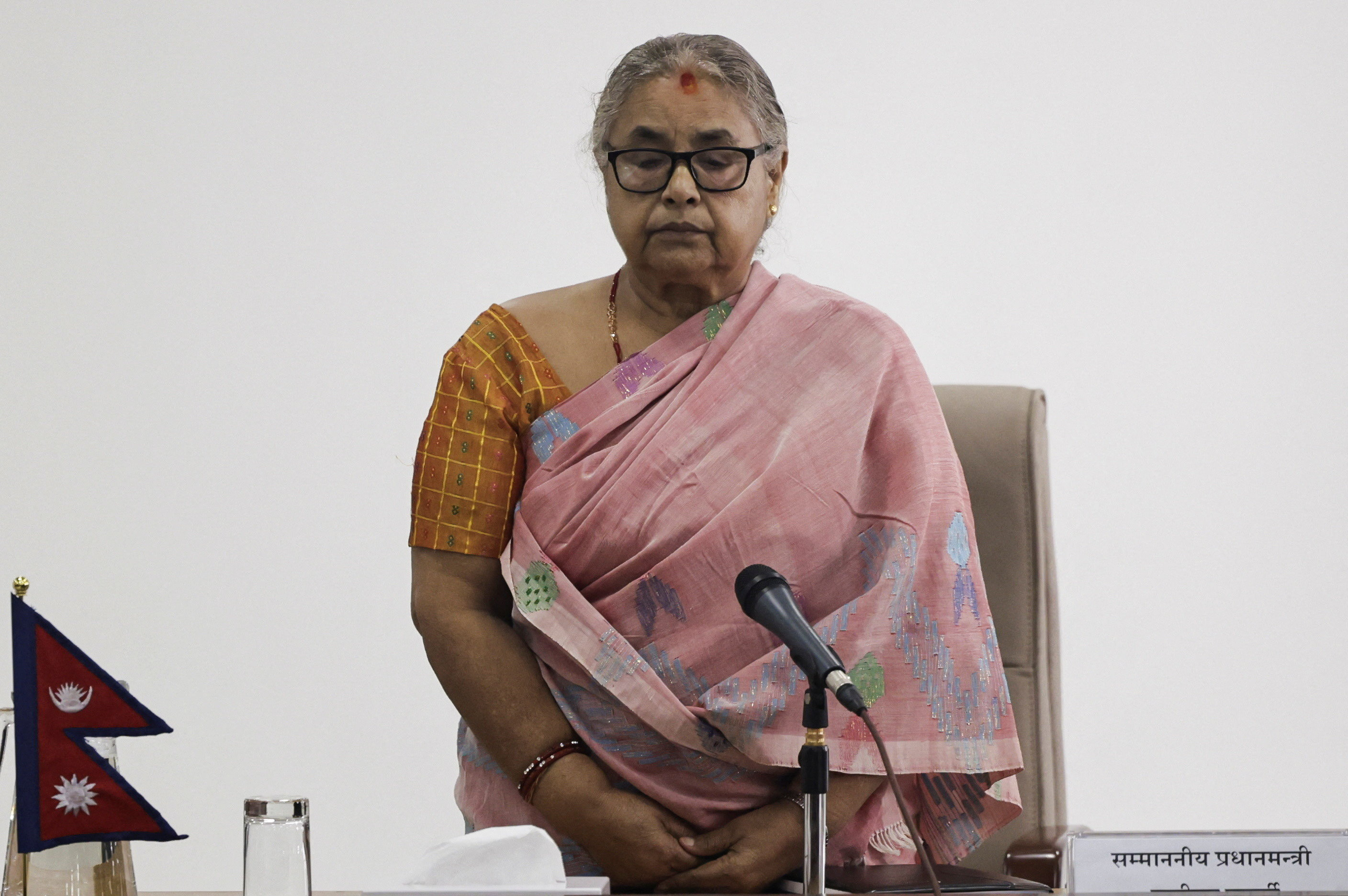 Newly sworn-in interim Prime Minister of Nepal, Sushila Karki, take part in a moment of silence in memory of people who died in a protest, during a meeting after assuming the post in her office at Singha Durbar office complex that houses the Prime Minister's office and other ministries, following the protest against anti-corruption triggered by a social media ban, which was later lifted, in Kathmandu, Nepal, September 14, 2025. REUTERS/Navesh Chitrakar TPX IMAGES OF THE DAY