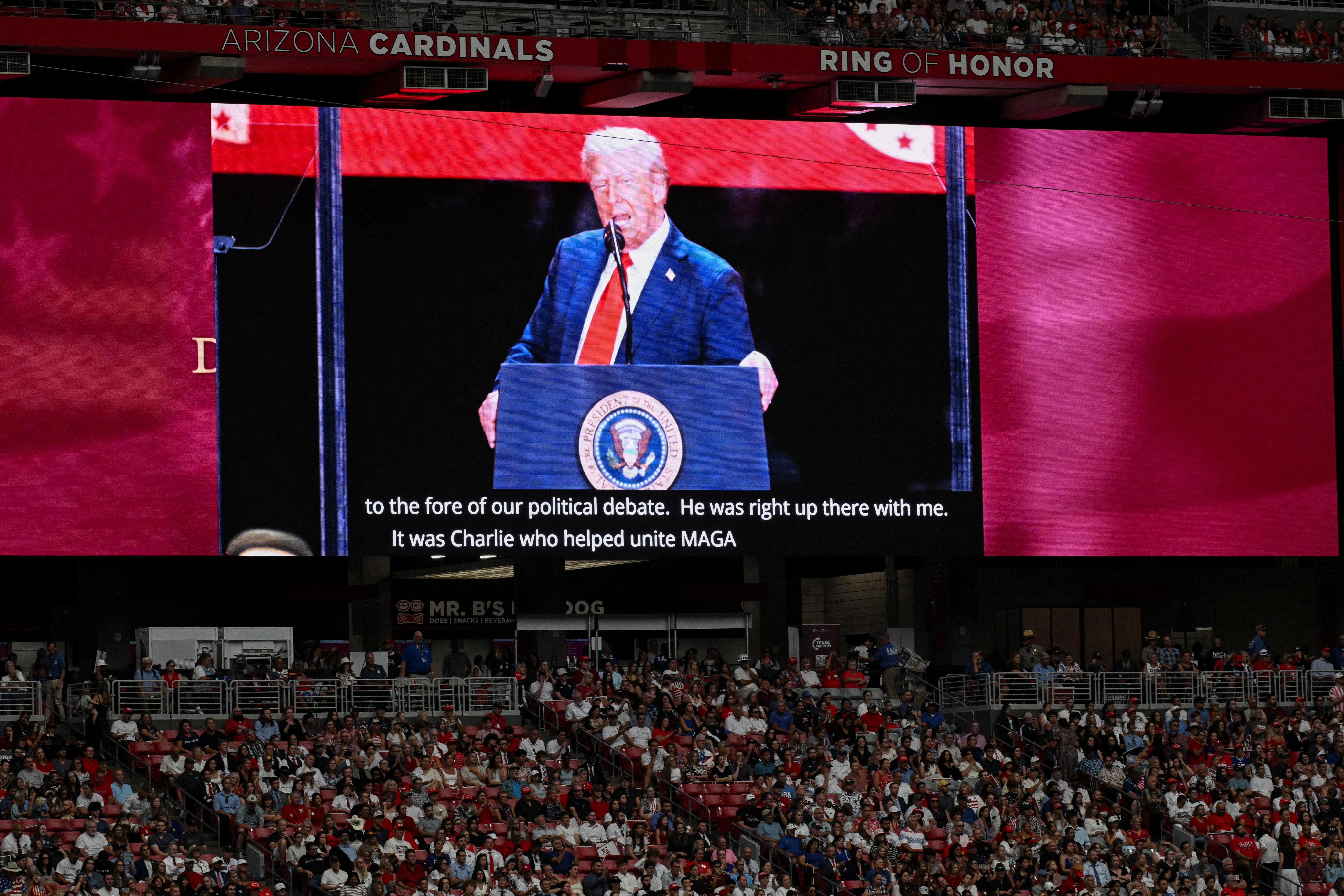U.S. President Donald Trump appears on a giant screen during a memorial service for slain conservative commentator Charlie Kirk at State Farm Stadium in Glendale, Arizona, U.S., September 21, 2025. REUTERS/Caitlin O'Hara
