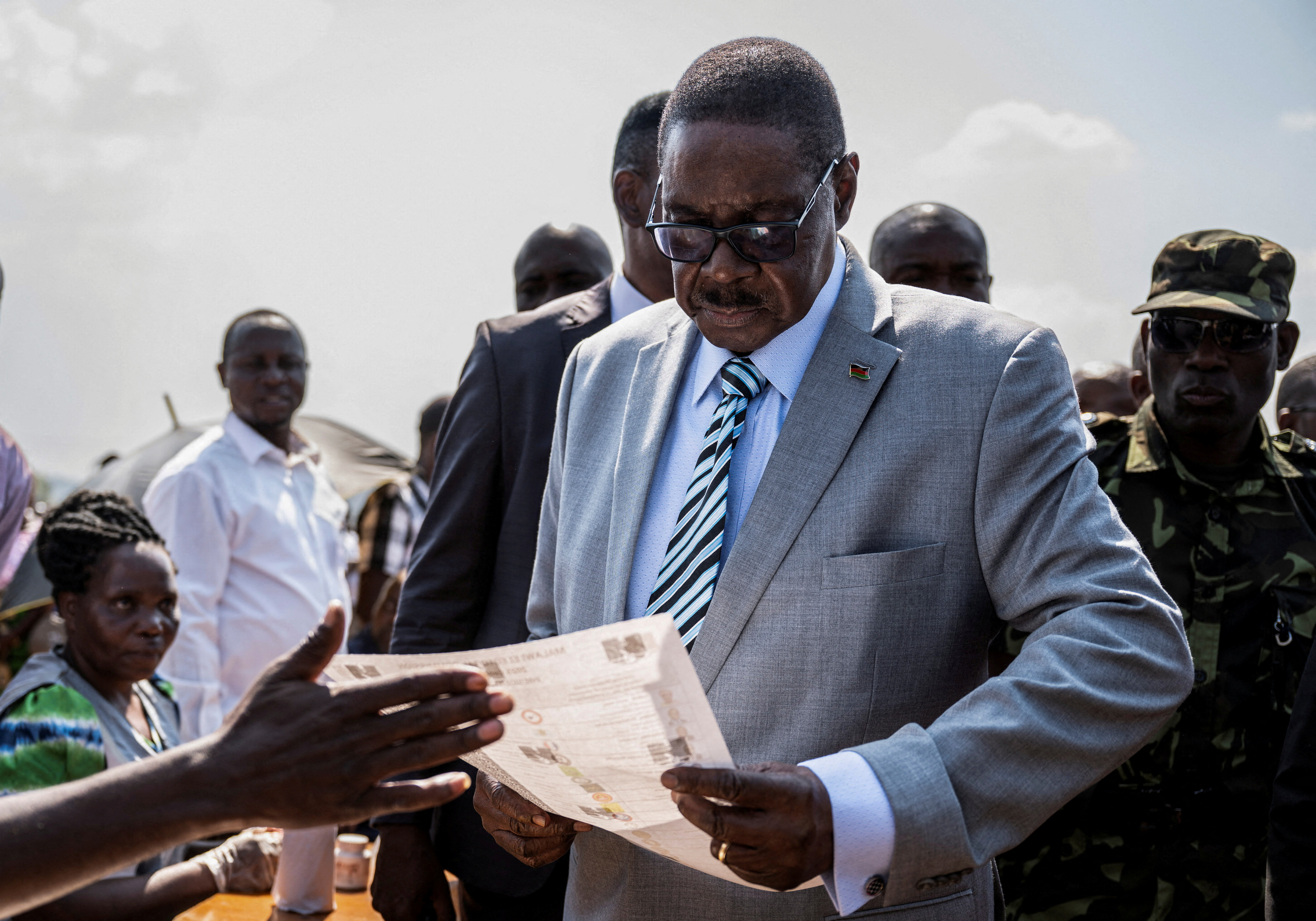 Malawi's presidential candidate and leader of the Democratic Progressive Party Peter Mutharika inspects a ballot paper before casting his vote during the general election at Thyolo District, south of Blantyre, Malawi, September 16, 2025. REUTERS/Stringer