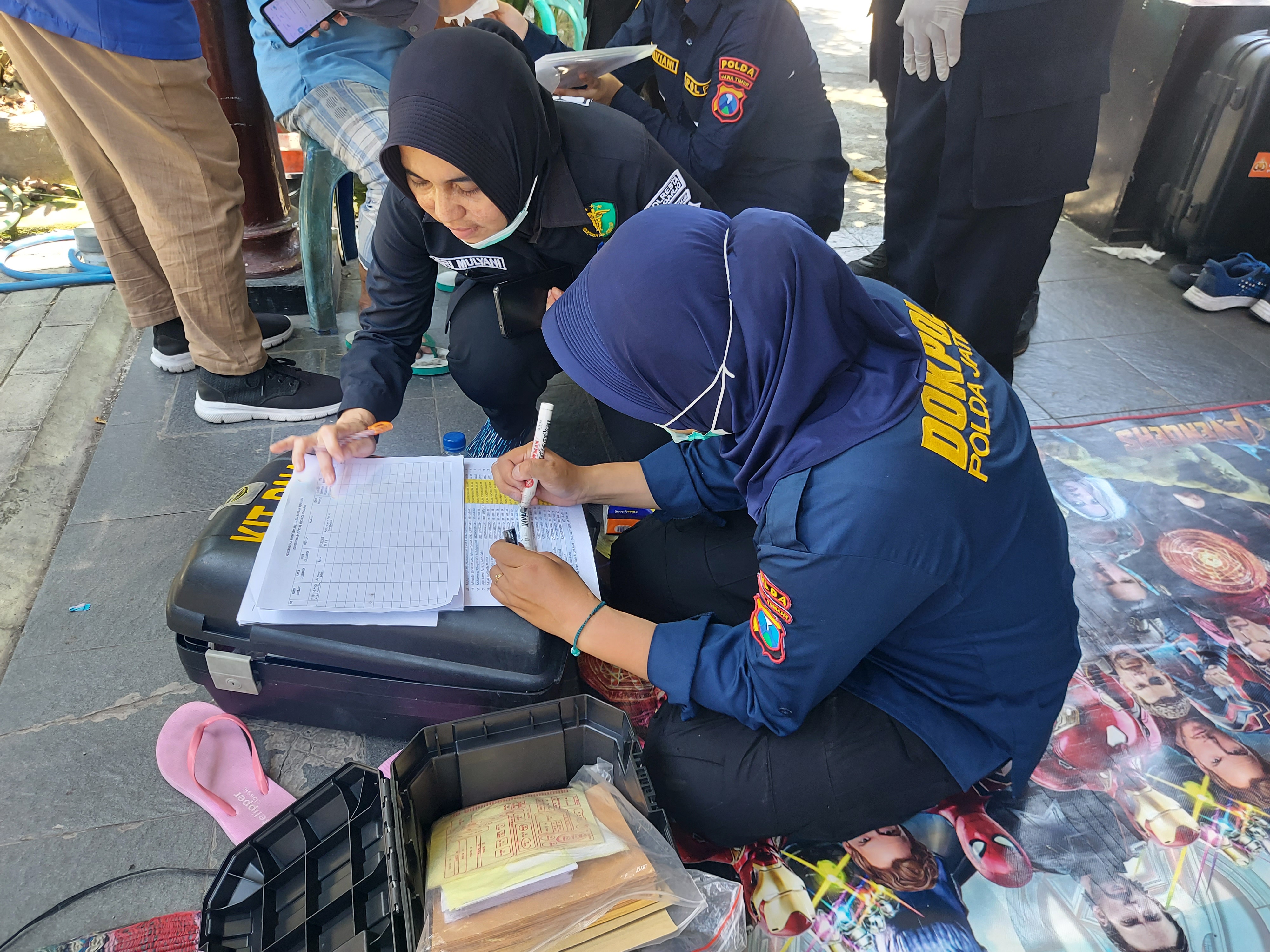 Medical teams take buccal swabs of relatives to match their DNA with the deceased. Photo credit: Aisyah Llewellyn