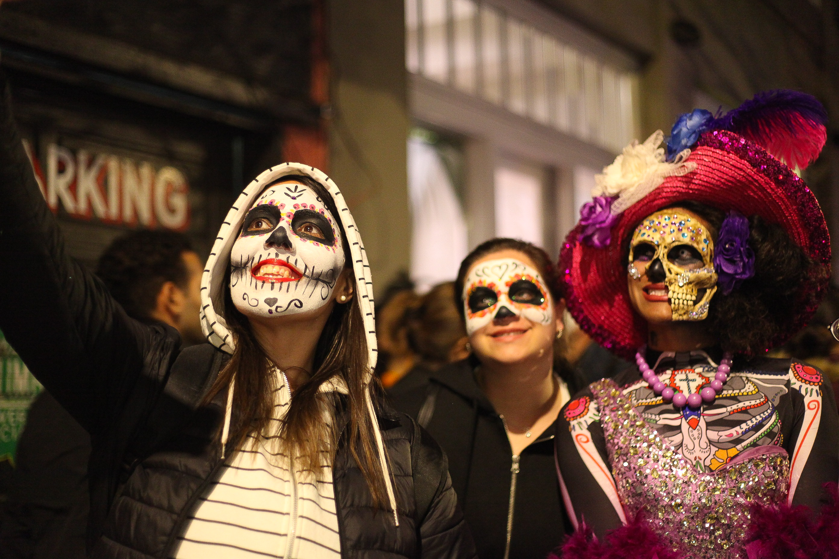 Women take a selfie with Catrina face paint
