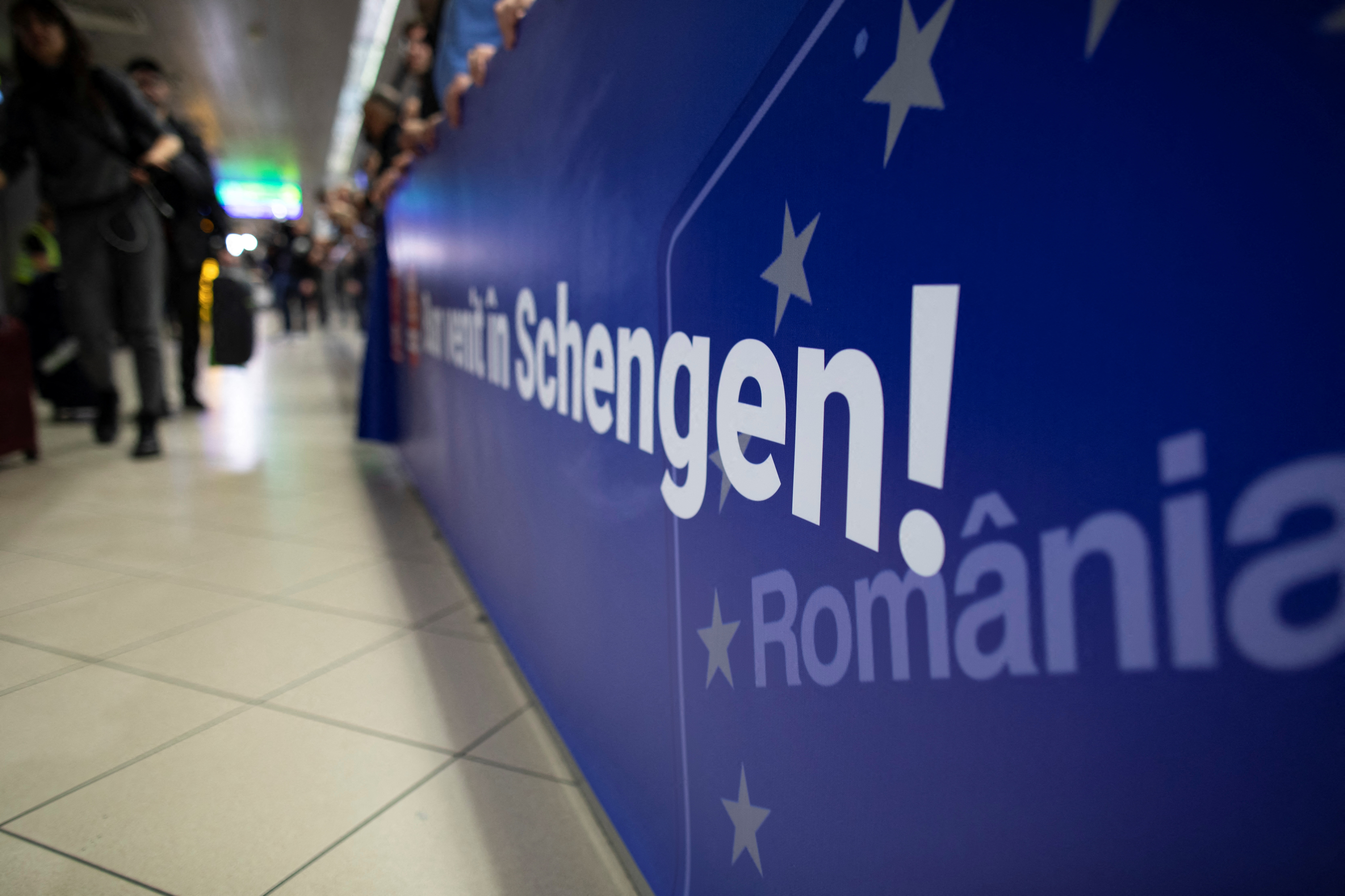 A banner reading 'Welcome to Schengen' at arrivals at Henri Coanda airport in Otopeni near Bucharest, Romania