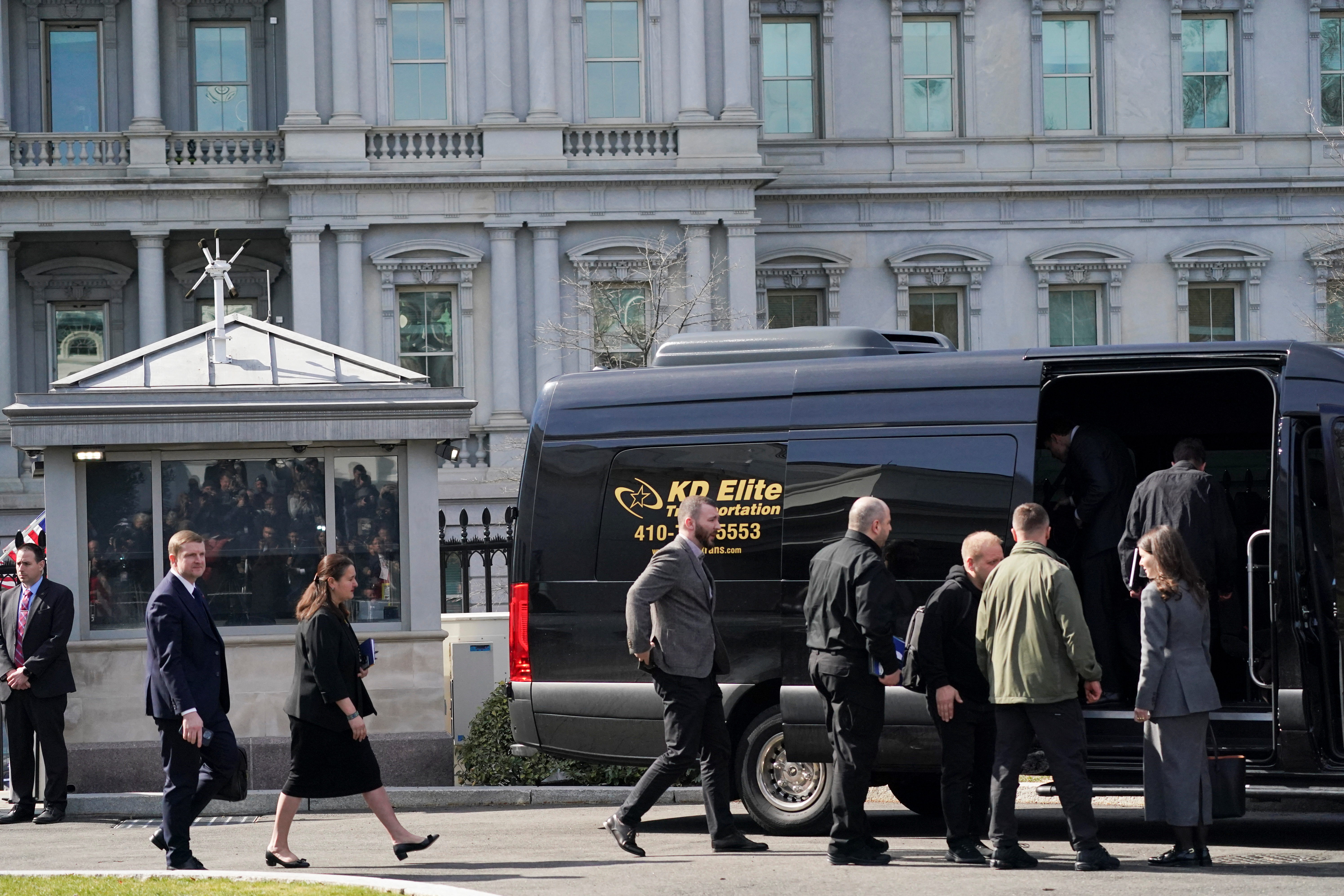 The Ukrainian delegation walks out of the White House in a line.