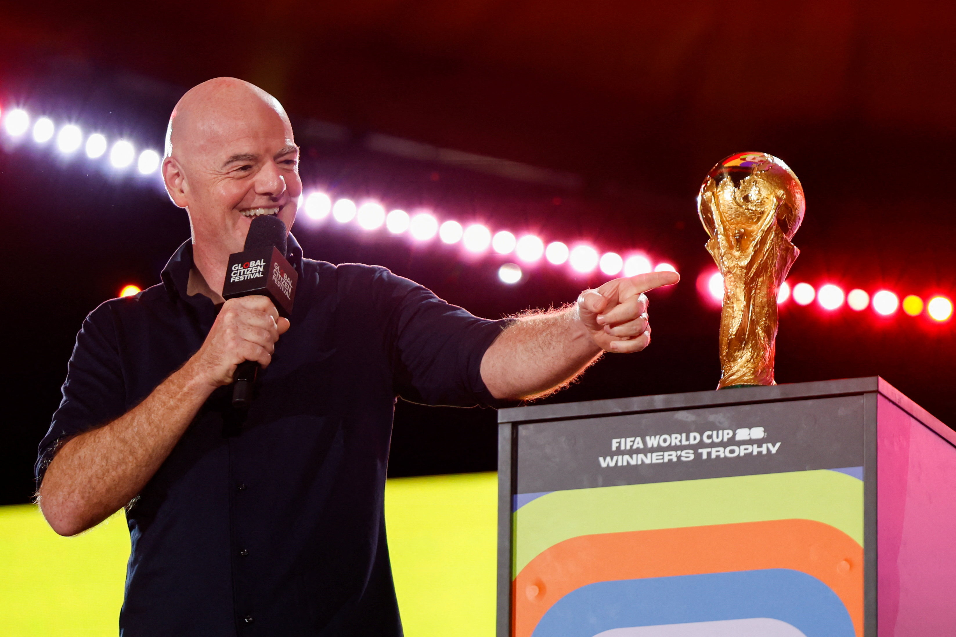 FIFA president Gianni Infantino gestures to the 2026 FIFA World Cup winner's trophy during the 2025 Global Citizen Festival in New York City, U.S.