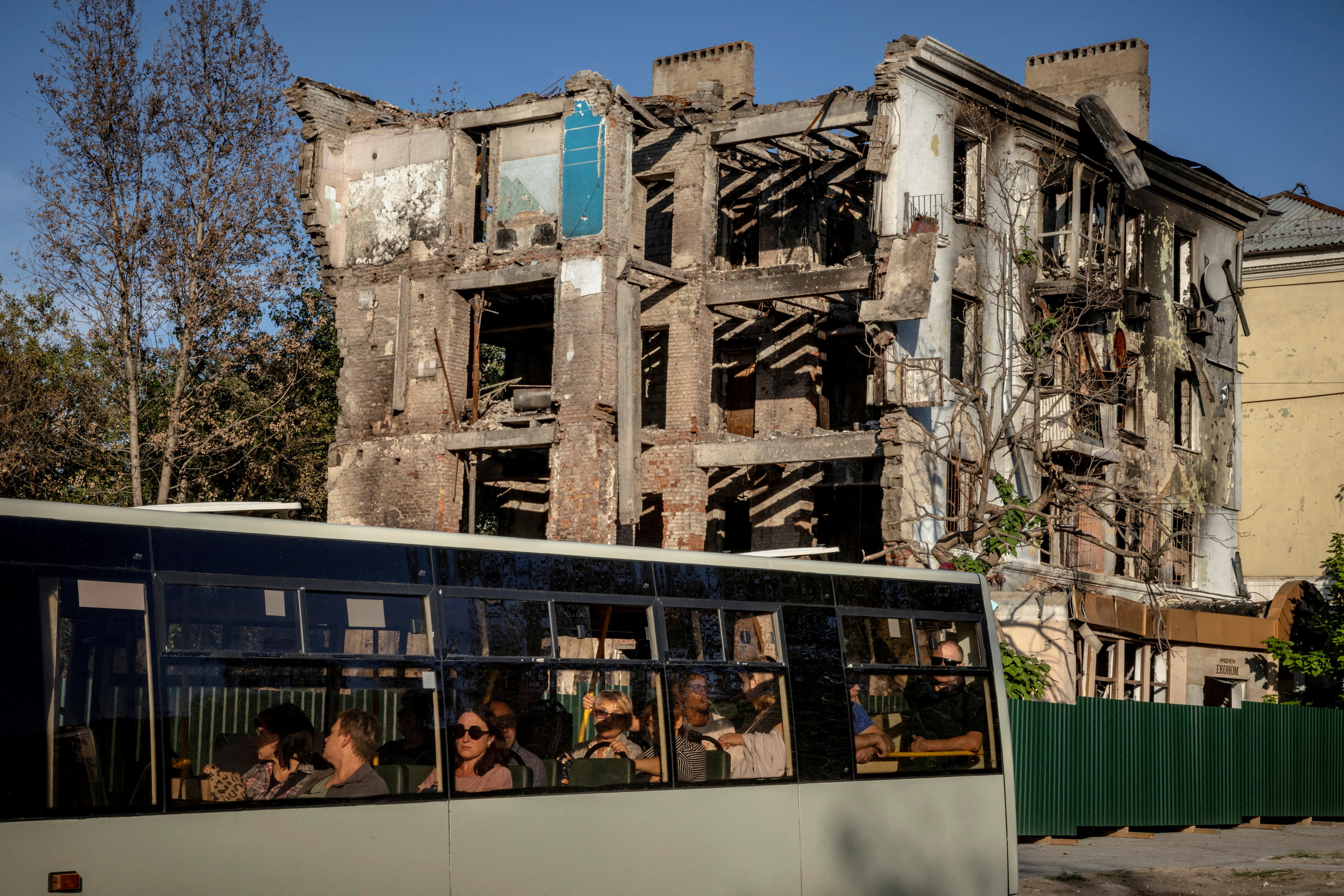 A local bus drives past an apartment building that was destroyed by a Russian missile in July this year, amid Russia's attack on Ukraine, in the frontline city of Kramatorsk, Ukraine September 10, 2025. REUTERS/Thomas Peter TPX IMAGES OF THE DAY