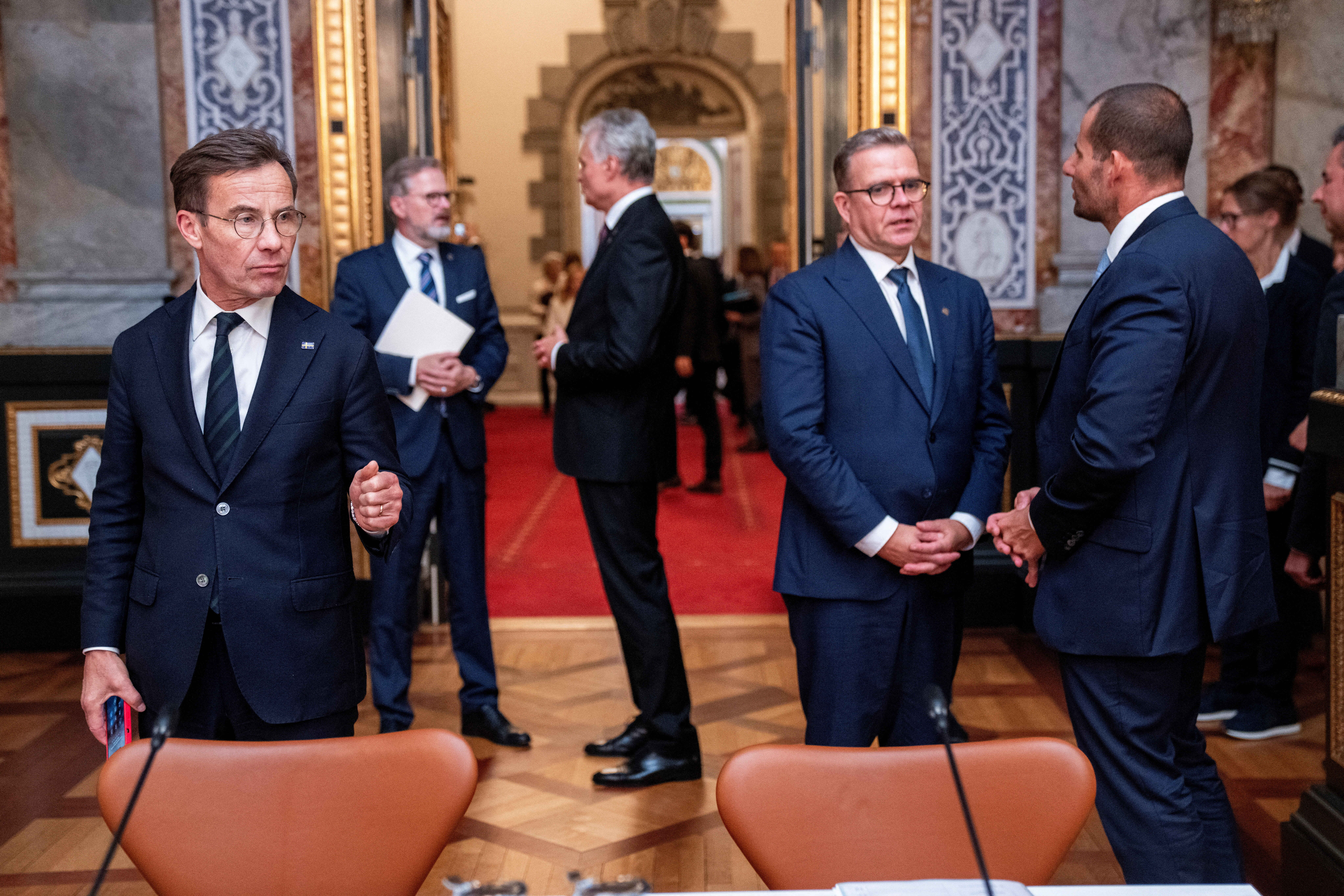 Sweden's Prime Minister, Ulf Kristersson, stands as Finland's Prime Minister, Petteri Orpo, speaks to Malta's Prime Minister, Robert Abela, at an informal summit in the Danish Parliament at Christiansborg Castle in Copenhagen, Denmark, October 1, 2025. Ritzau Scanpix/Ida Marie Odgaard via REUTERS ATTENTION EDITORS - THIS IMAGE WAS PROVIDED BY A THIRD PARTY. DENMARK OUT. NO COMMERCIAL OR EDITORIAL SALES IN DENMARK.