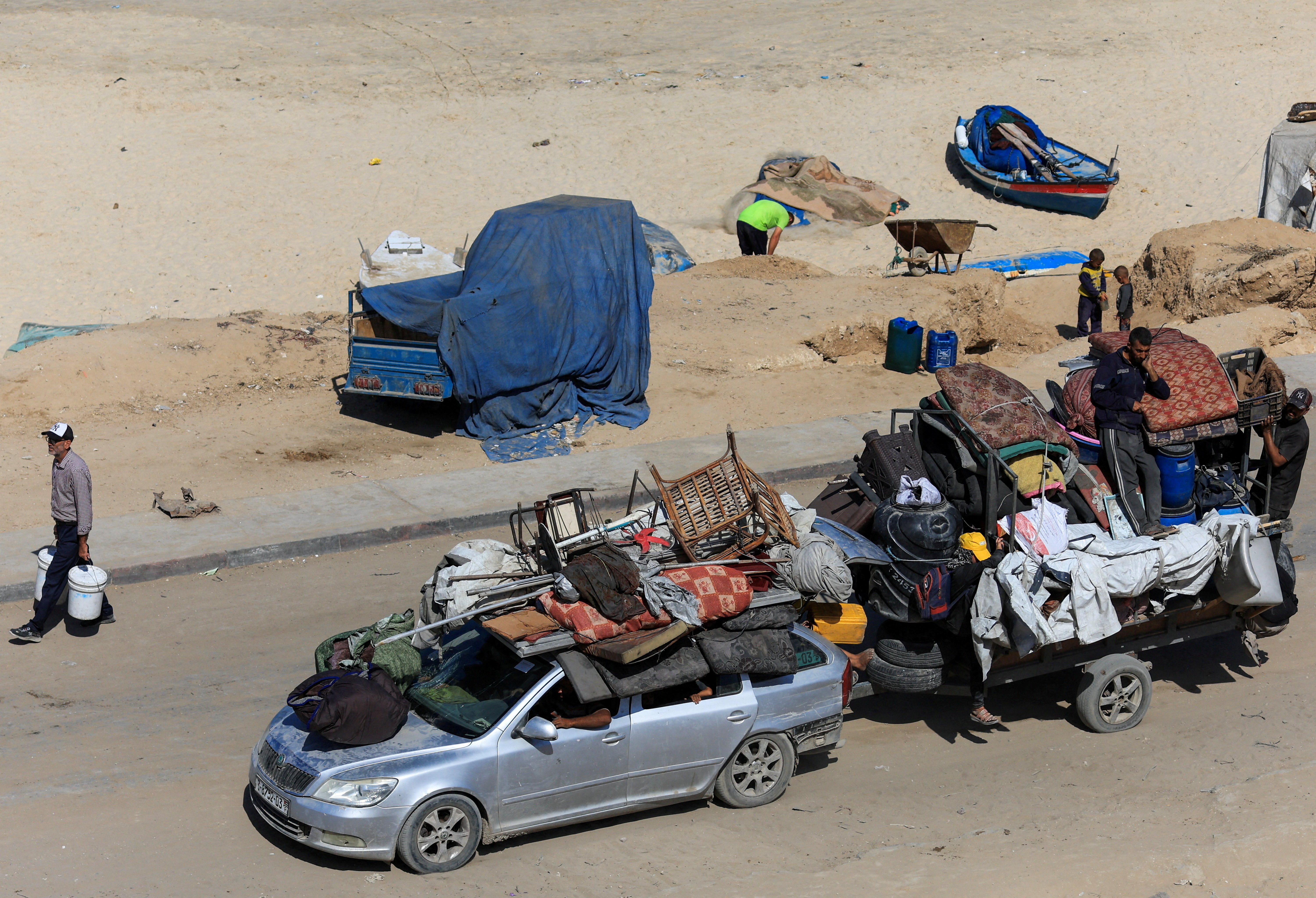 Displaced Palestinians fleeing northern Gaza due to an Israeli military operation, travel with belongings as they move southward, after Israeli forces ordered residents of Gaza City to evacuate to the south, in the central Gaza Strip