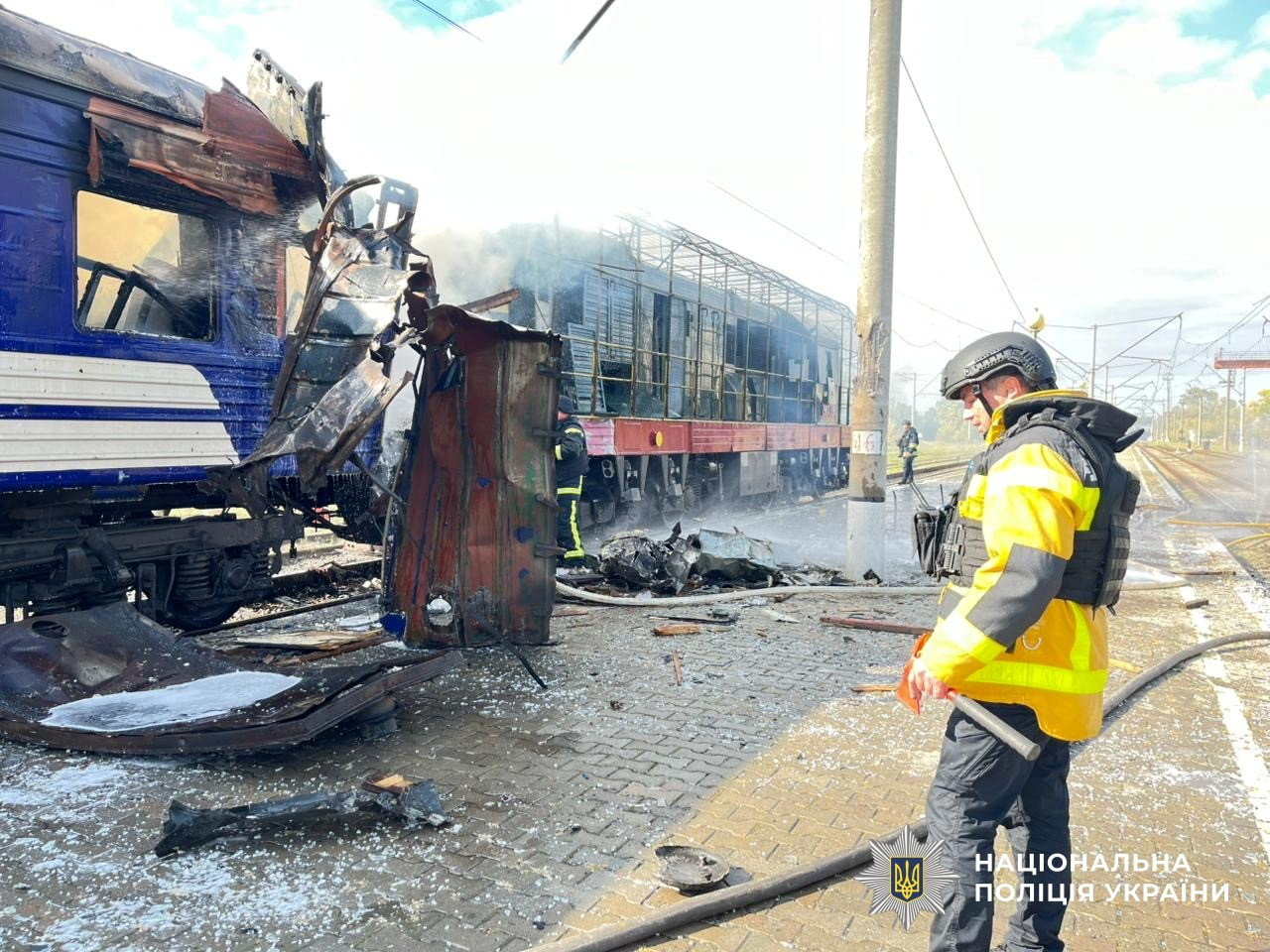 Firefighters work next to a passenger train hit by today's Russian drone strike, amid Russia's attack on Ukraine, at the railway station in the town of Shostka, Sumy region, Ukraine October 4, 2025. Press service of the State National Police of Ukraine in Sumy region/Handout via REUTERS ATTENTION EDITORS - THIS IMAGE HAS BEEN SUPPLIED BY A THIRD PARTY. DO NOT OBSCURE LOGO. BEST QUALITY AVAILABLE.