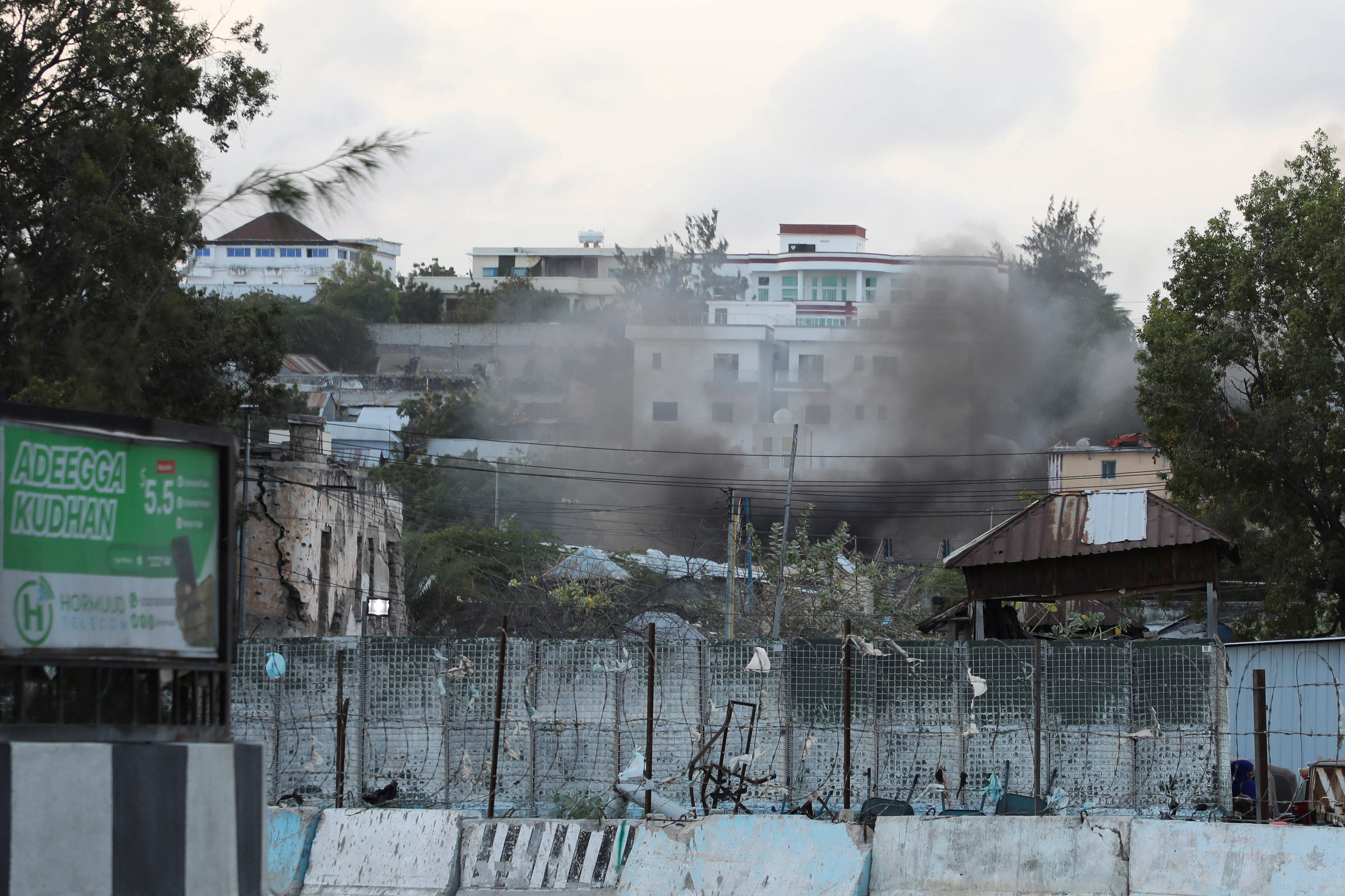 Smoke billows from a compound near the presidential palace, following explosions in Mogadishu, Somalia