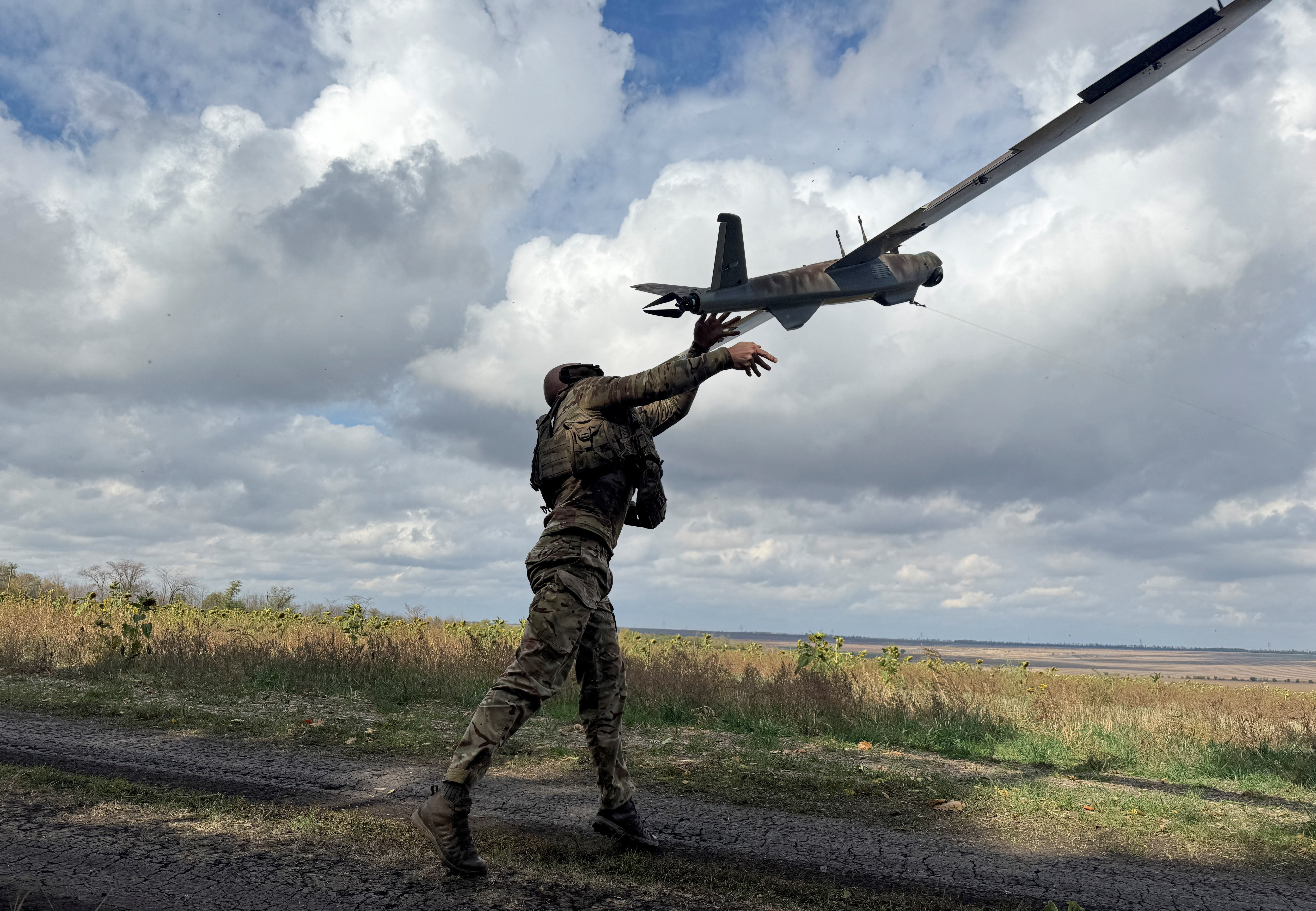 A serviceman of the 59th Separate Assault Brigade of Unmanned Systems named after Yakov Handziuk of the Armed Forces of Ukraine, launches a reconnaissance drone, amid Russia's attack on Ukraine, near the frontline town of Pokrovsk in Donetsk region, Ukraine October 6, 2025. REUTERS/Stringer