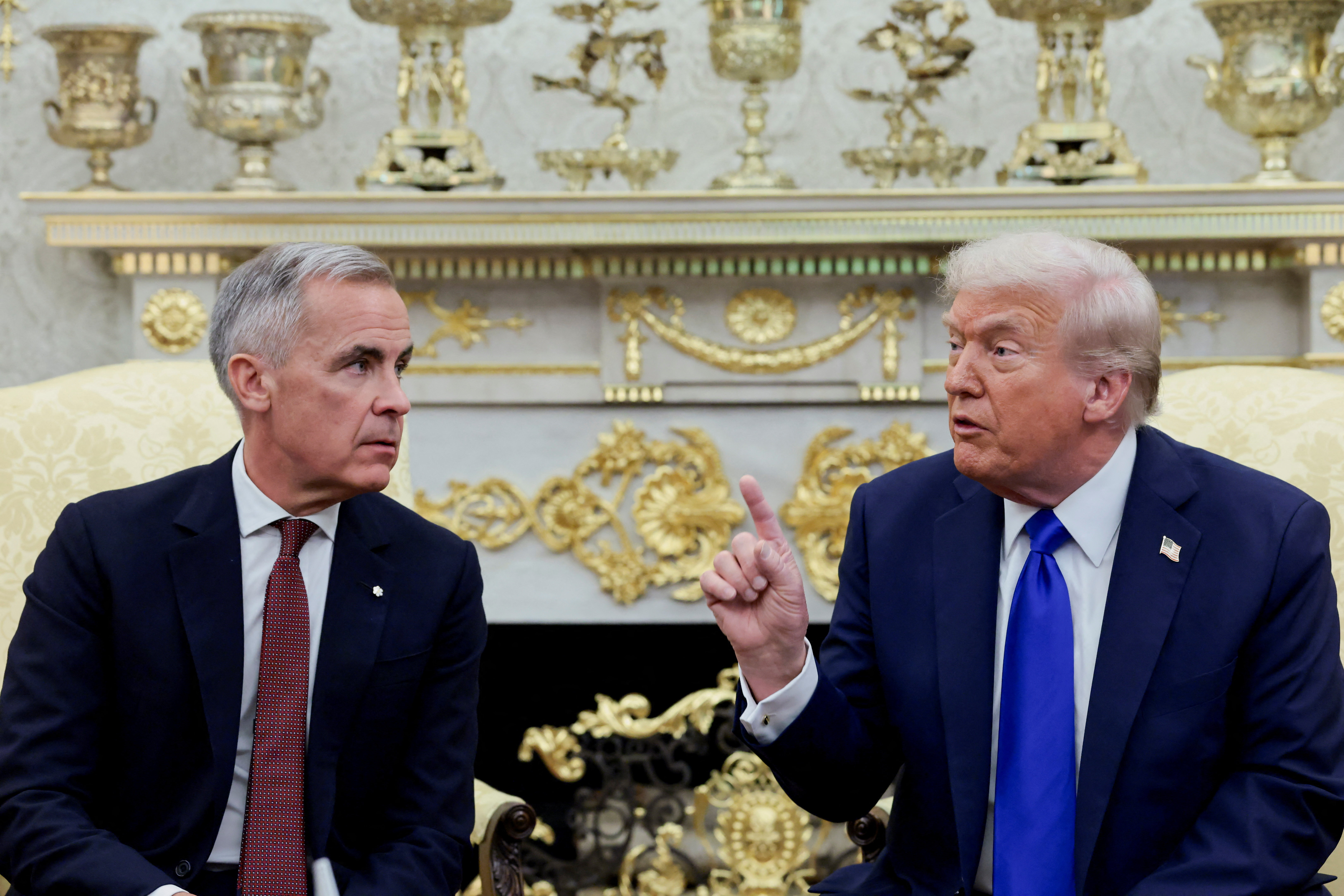 U.S. President Donald Trump gestures as he and Canada's Prime Minister Mark Carney meet in the Oval Office at the White House in Washington, D.C., US, October 7, 2025. REUTERS/Evelyn Hockstein