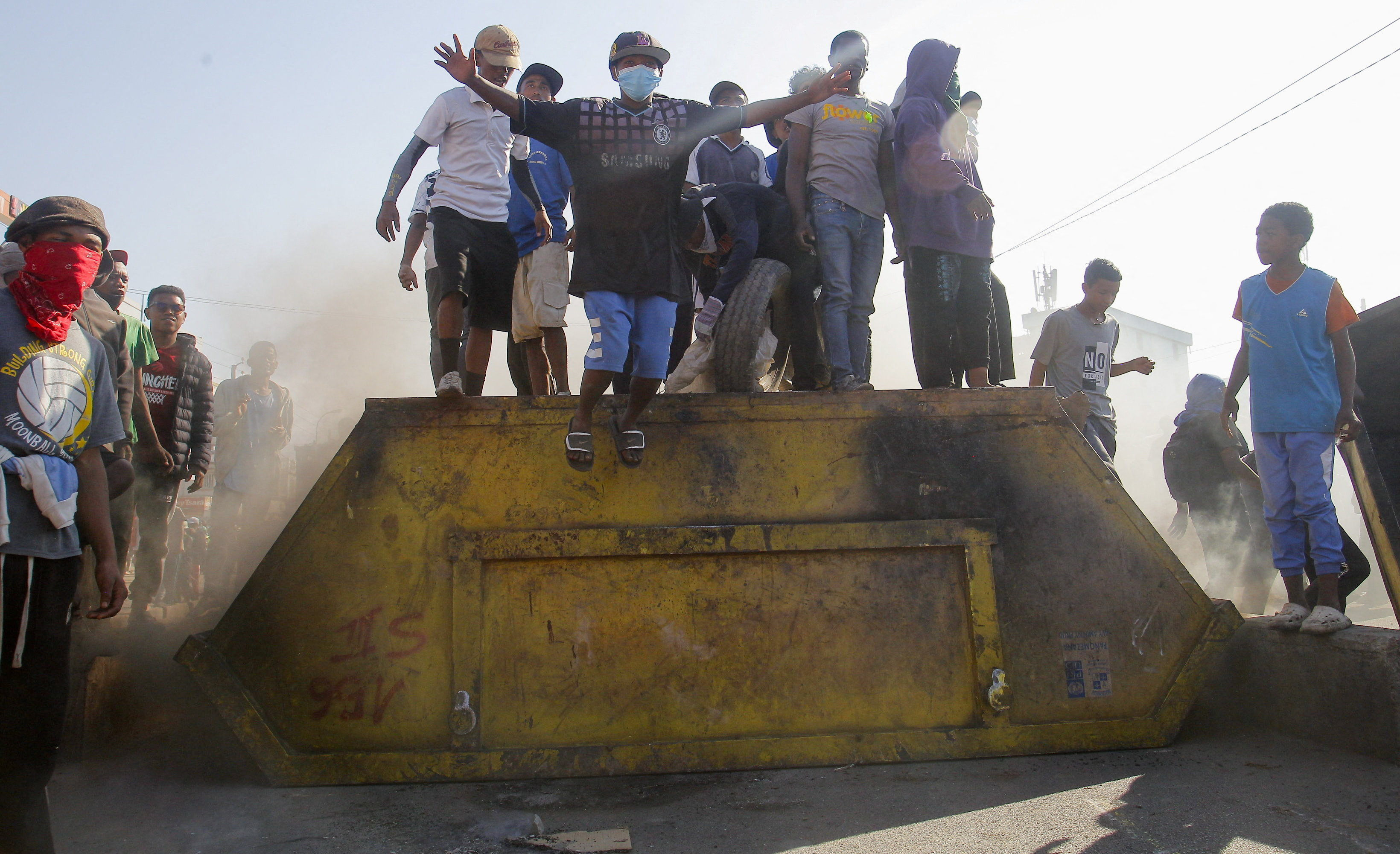 Protesters stand on a steel dumpster as they block a road during a nationwide youth-led protest in Madagascar [Zo Andrianjafy/Reuters]