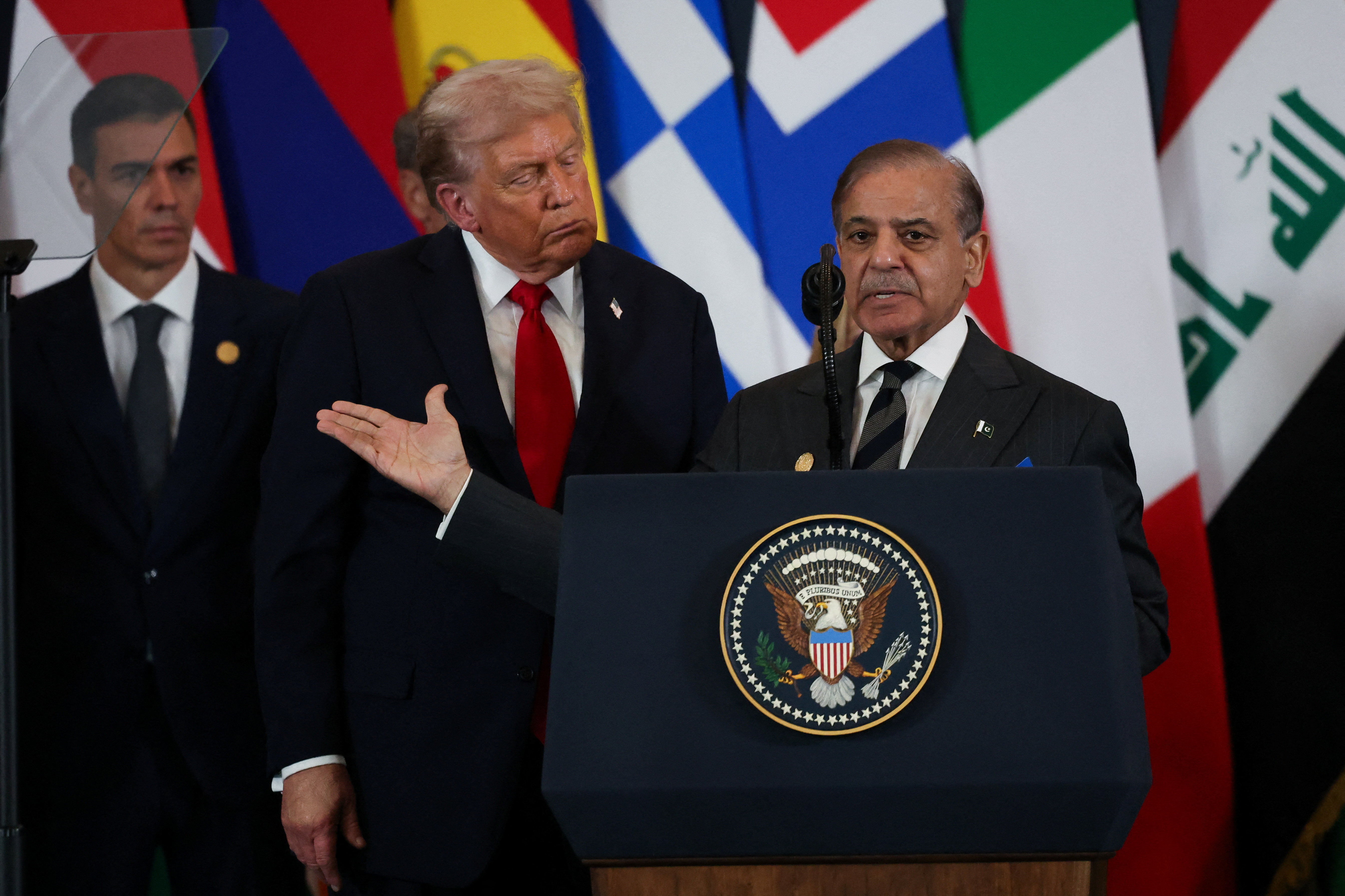 Pakistani Prime Minister Shehbaz Sharif speaks next to U.S. President Donald Trump during world leaders' summit on ending the Gaza war, amid a U.S.-brokered prisoner-hostage swap and ceasefire deal between Israel and Hamas, in Sharm el-Sheikh, Egypt, October 13, 2025. REUTERS/Suzanne Plunkett/Pool