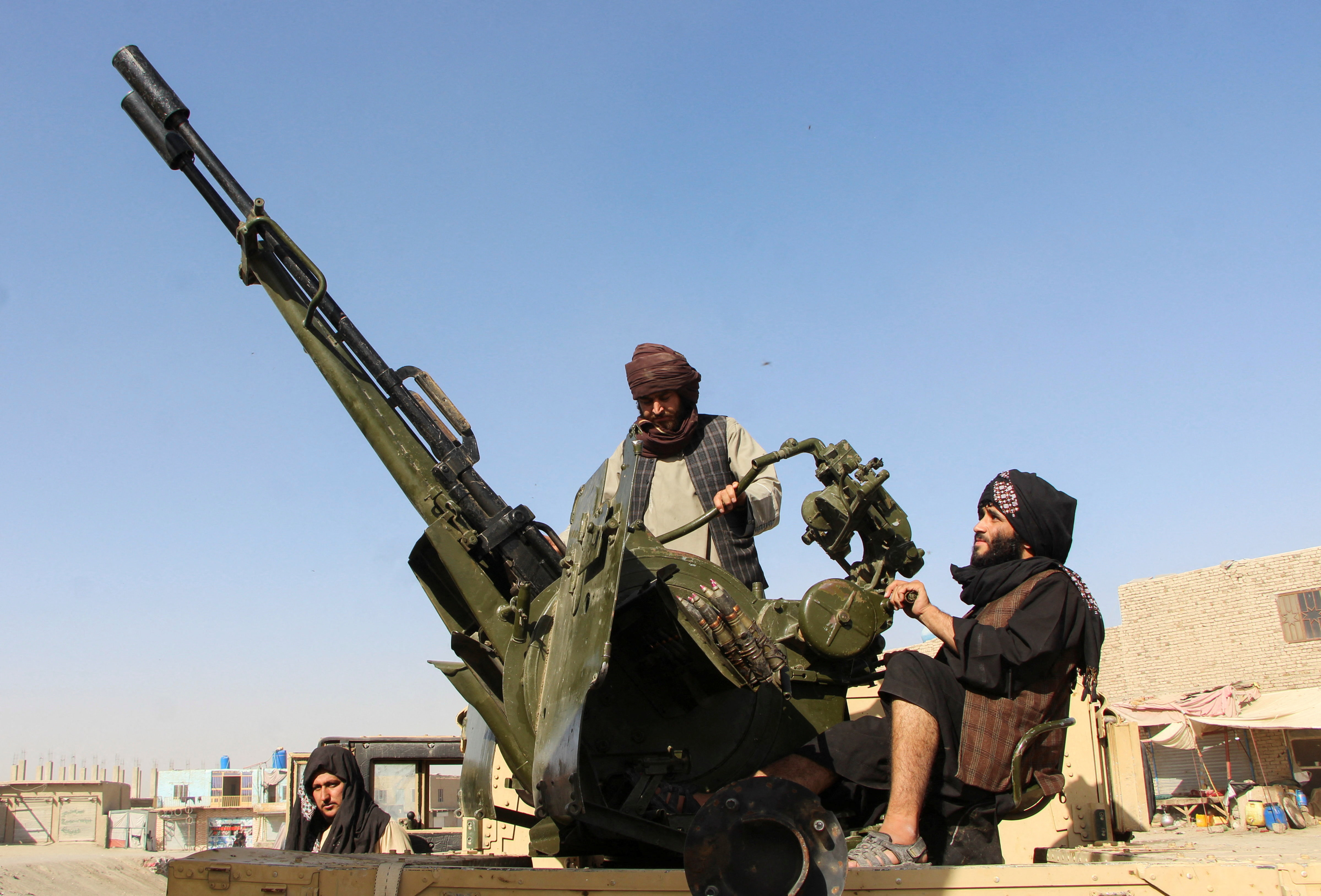 An Afghan Taliban fighter sit next to an anti-aircraft gun near the Afghanistan-Pakistan border in Spin Boldak, Kandahar Province, following exchanges of fire between Pakistani and Afghan forces in Afghanistan, October 15, 2025.