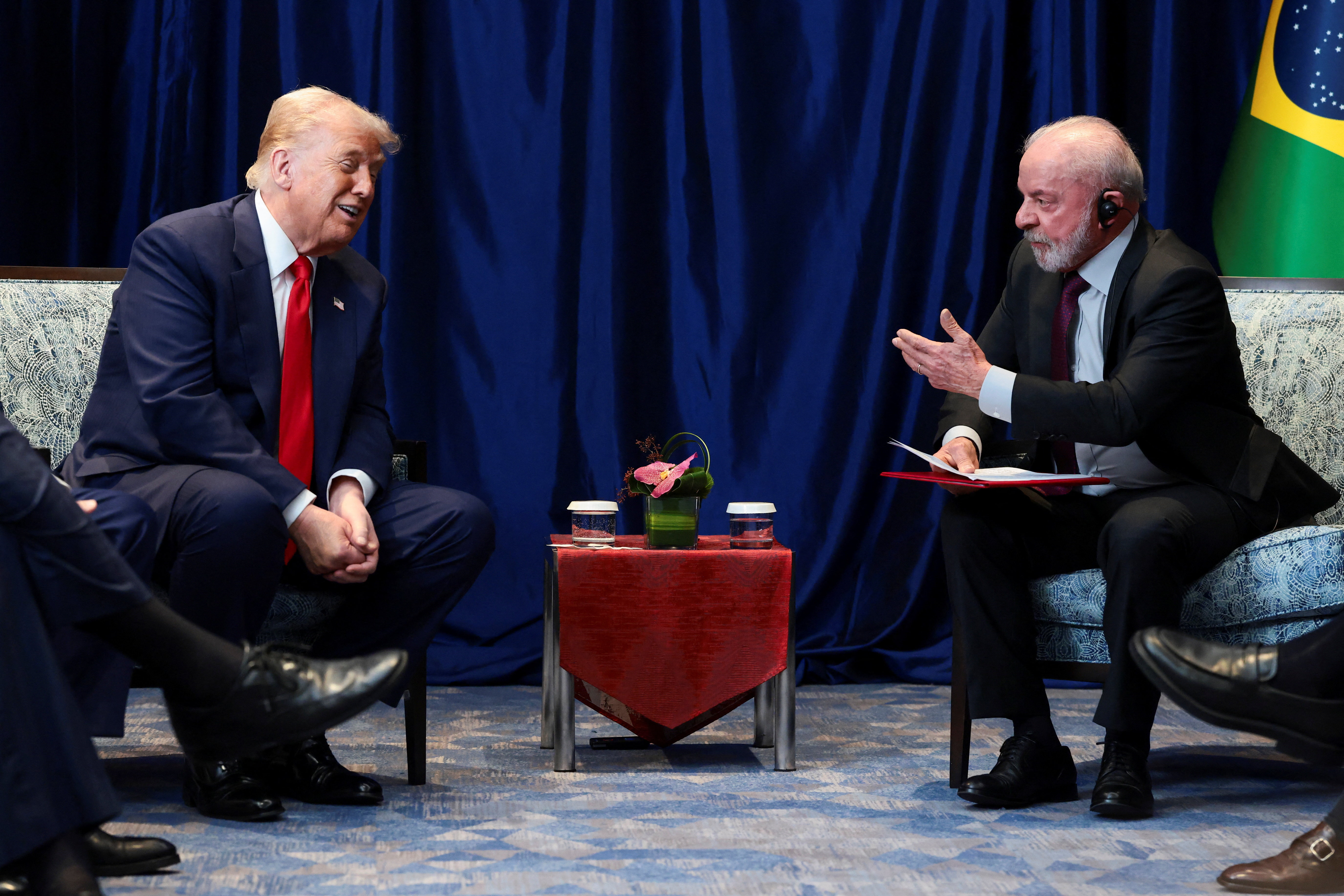 US President Donald Trump talks with Brazilian President Luiz Inacio Lula da Silva.