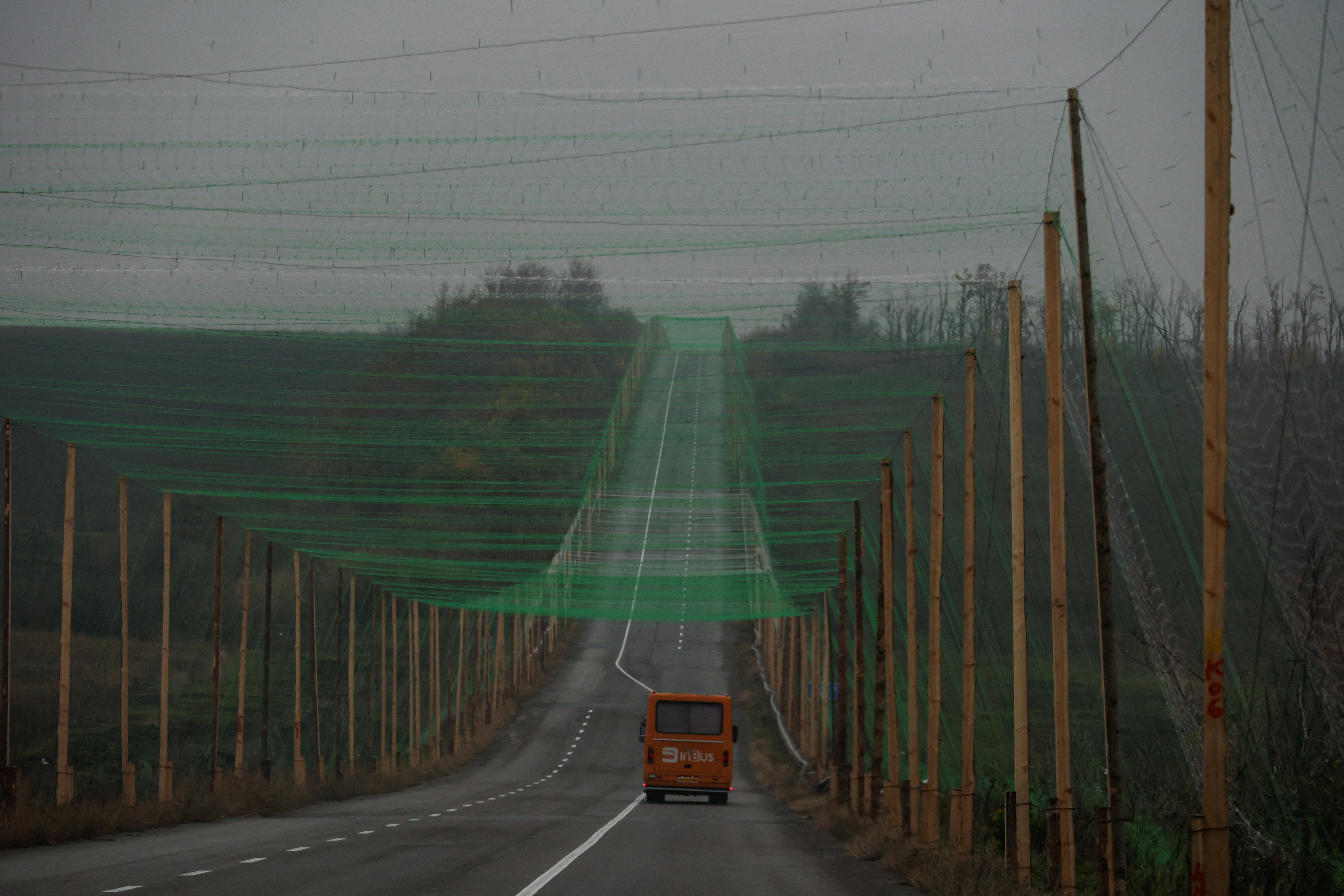 A car drives along a road covered with an anti-drone net, amid Russia's attack on Ukraine, near the town of Sloviansk in Donetsk region, Ukraine October 27, 2025. REUTERS/Sofiia Gatilova TPX IMAGES OF THE DAY