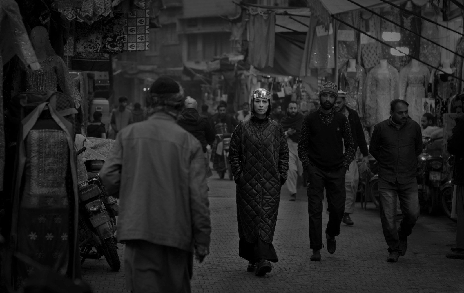 Still from the video for the song Khilnay Ko (To Bloom) featuring Meesha Shafi walking through a Lahore bazaar.