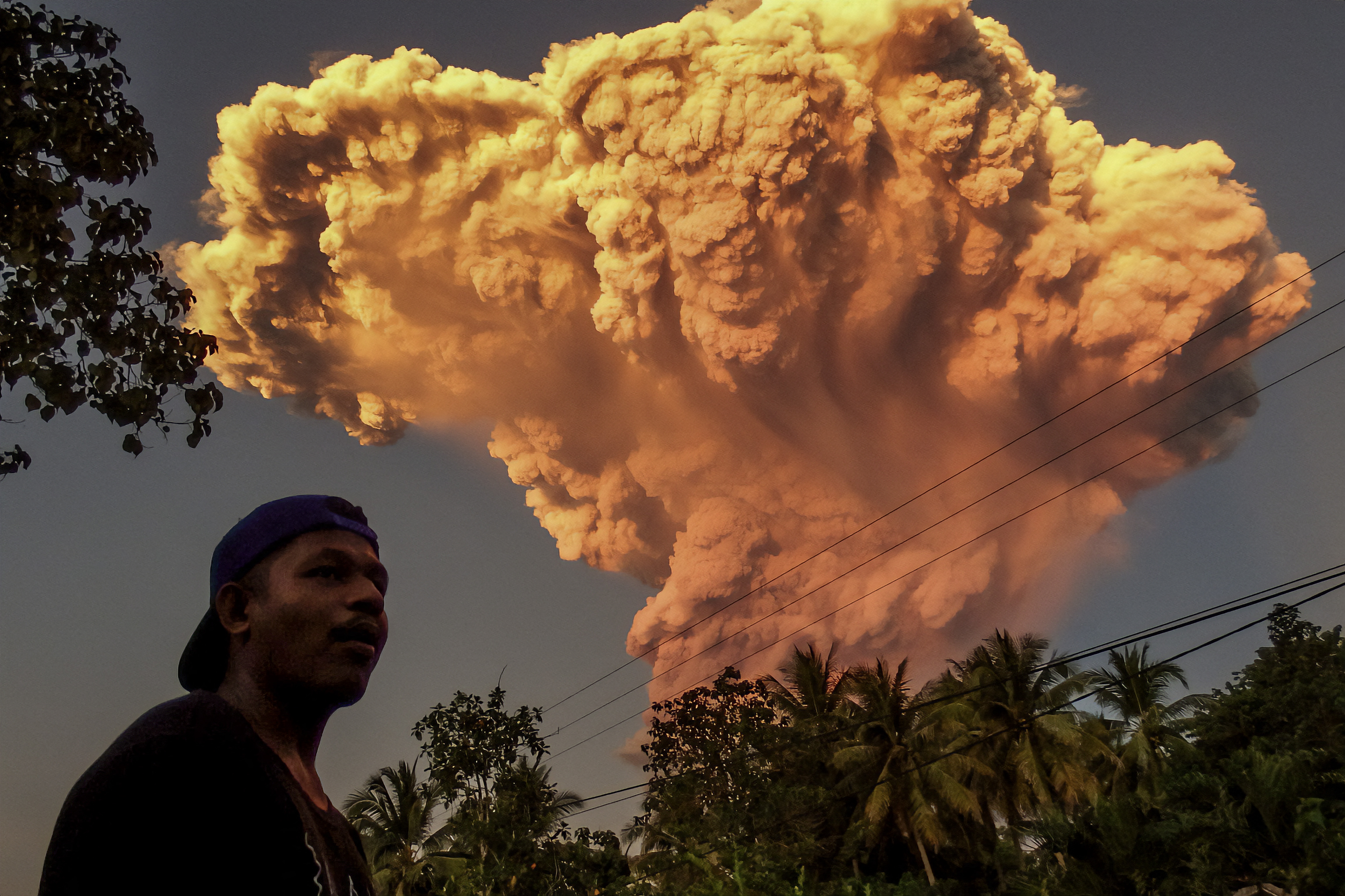 A villager watches the eruption of Mount Lewotobi Laki-Laki.