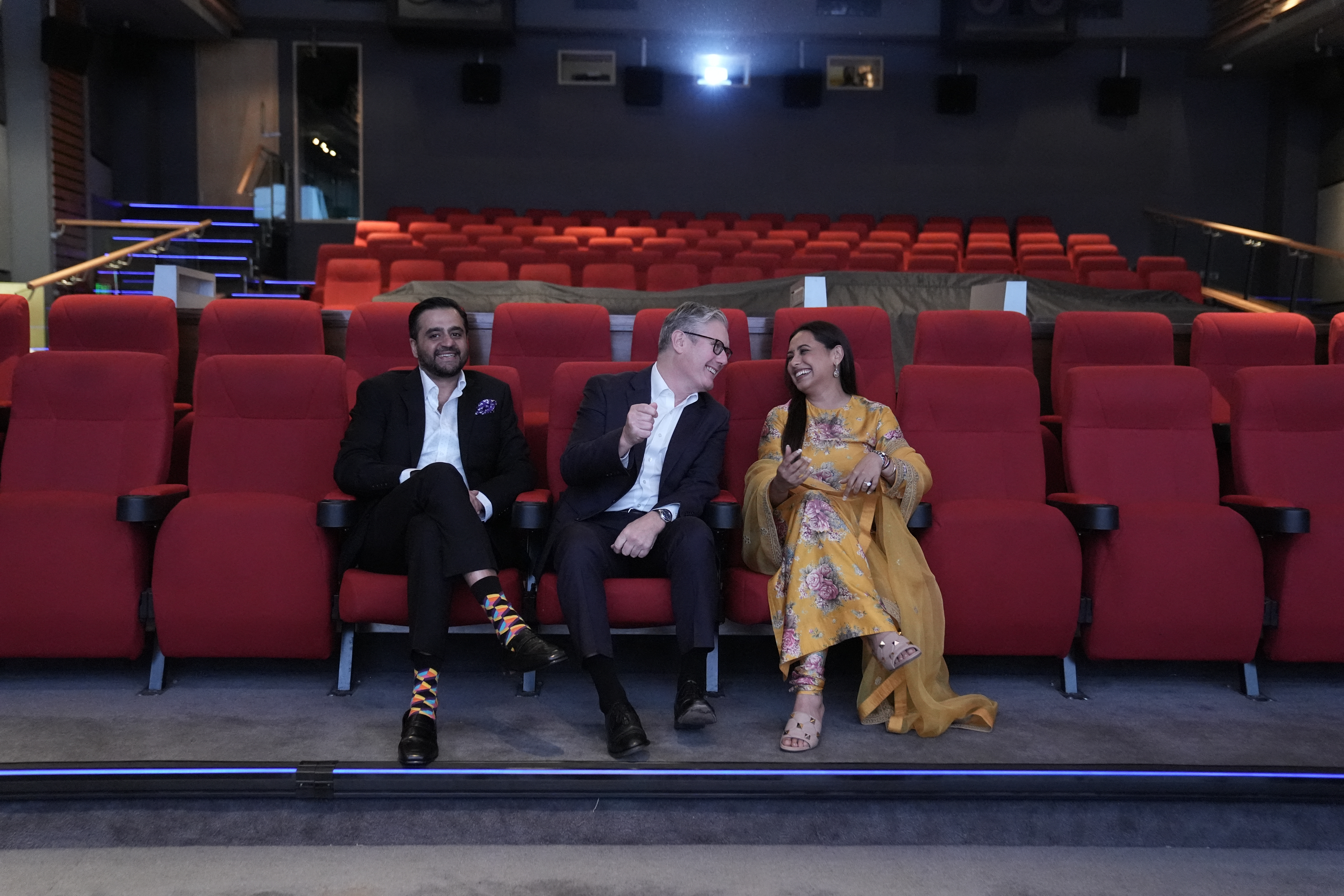 Yash Raj Films CEO Akshaye Widhani, Britain's Prime Minister Keir Starmer and Indian actress Rani Mukerji view a screening during a visit to Yash Raj Films, a Bollywood studio, in Mumbai