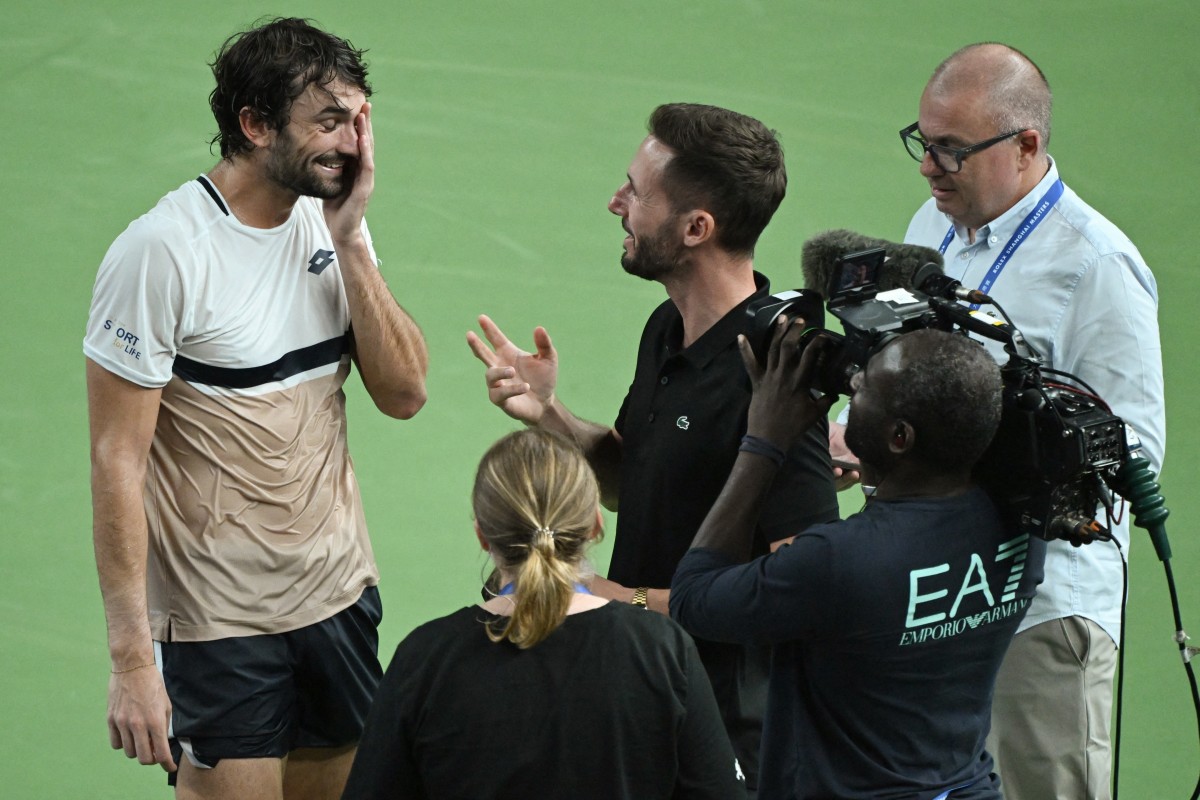 Monacos Valentin Vacherot (L) reacts during an interview after winning the mens singles semi-final match against Serbias Novak Djokovic at the Shanghai Masters tennis tournament in Shanghai on October 11, 2025. (Photo by Jade Gao / AFP)