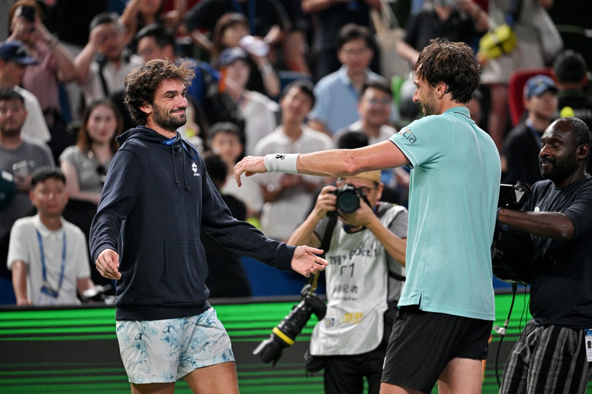 France's Arthur Rinderknech celebrates with Monacos Valentin Vacherot after winning against Russia's Daniil Medvedev at the end of their mens singles semi-final match during the Shanghai Masters tennis tournament in Shanghai on October 11, 2025. (Photo by Hector RETAMAL / AFP)