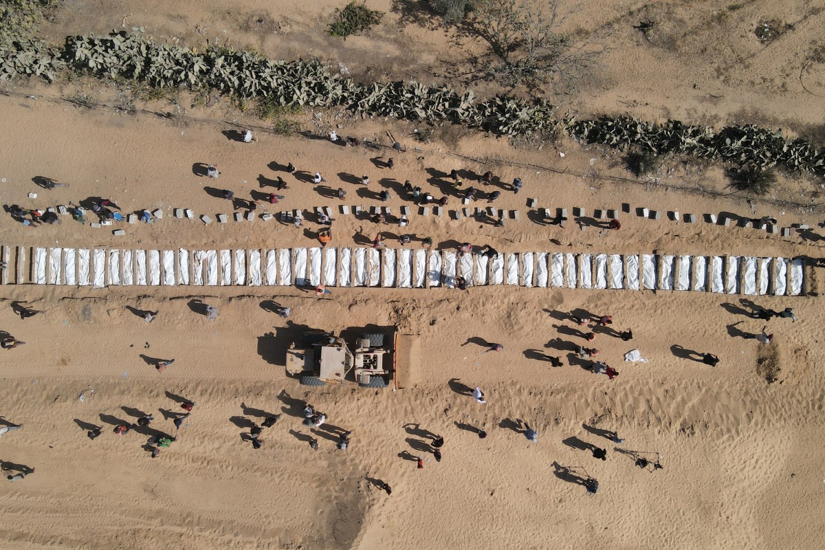 Families mourn as mass burial held for unidentified Palestinians in Gaza