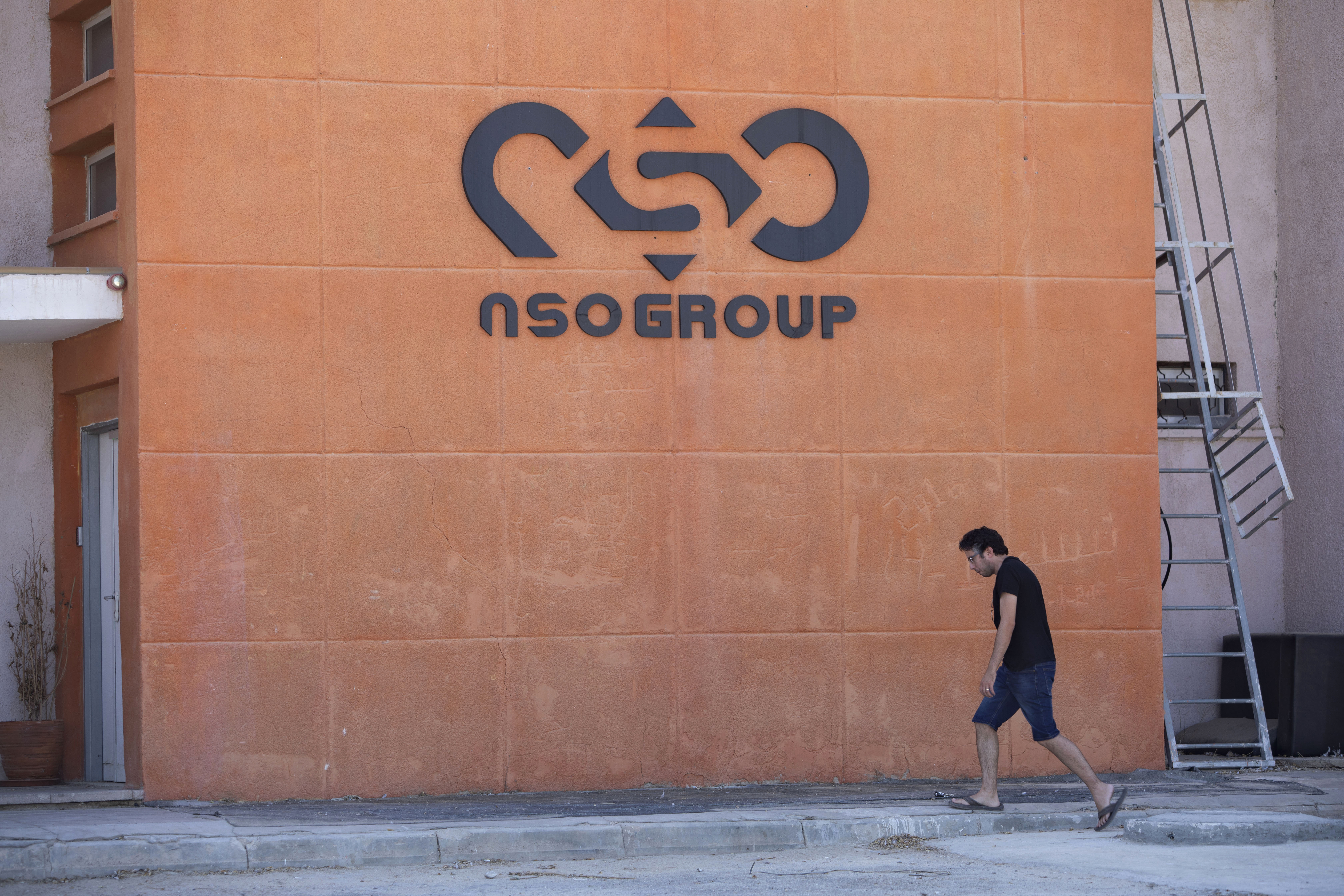 FILE - A logo adorns a wall on a branch of the Israeli NSO Group company, near the southern Israeli town of Sapir, Aug. 24, 2021. The third-largest group in the European Parliament has called for the establishment of a committee to investigate abuses by European Union governments with powerful spyware produced by Israel’s NSO Group. Renew Europe, a liberal political grouping, said Wednesday, Jan. 12, 2022 that the use of the software to break into the phones of government critics is “undermining democracy.” (AP Photo/Sebastian Scheiner, File)