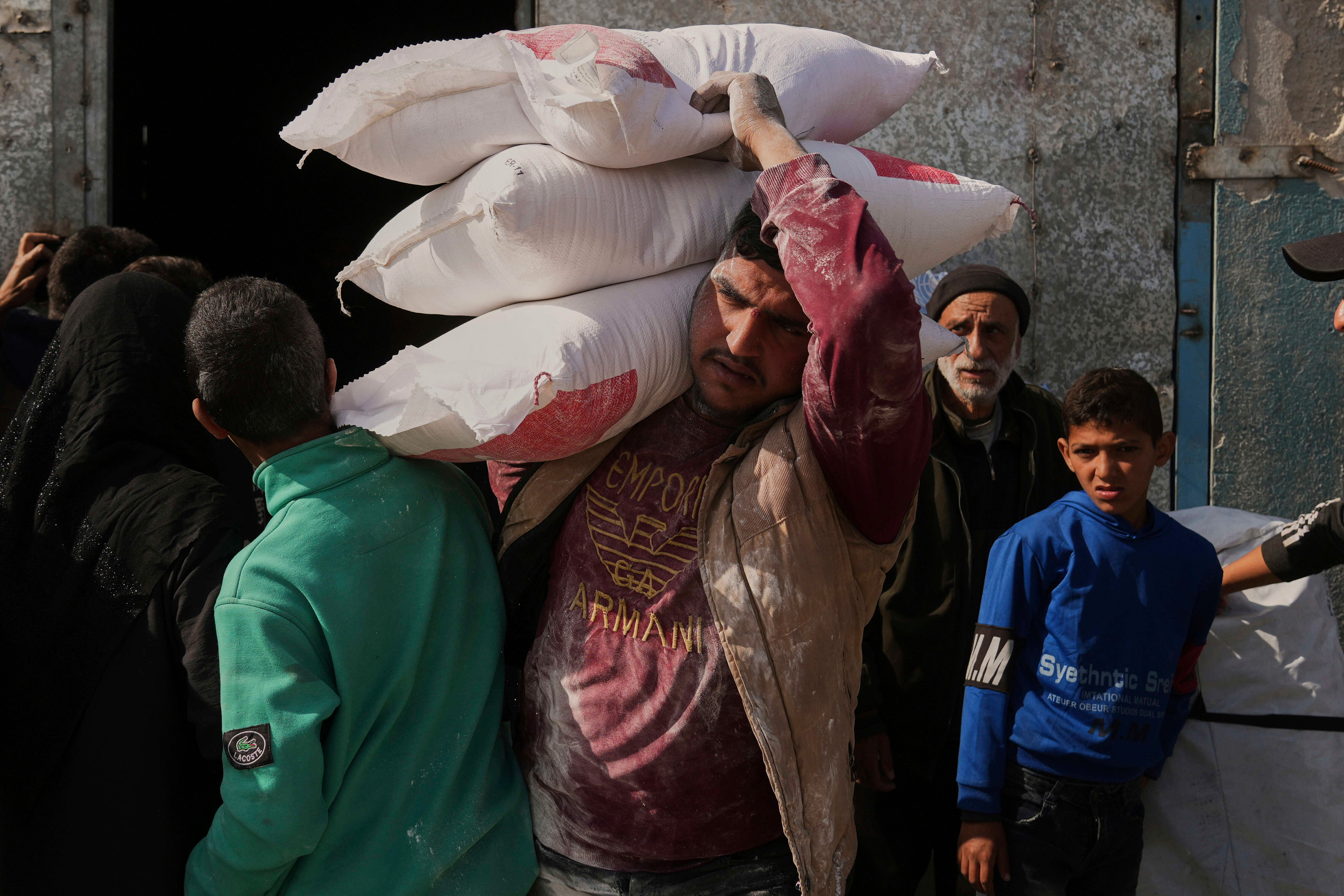 Palestinian man carries aid supplies in Gaza