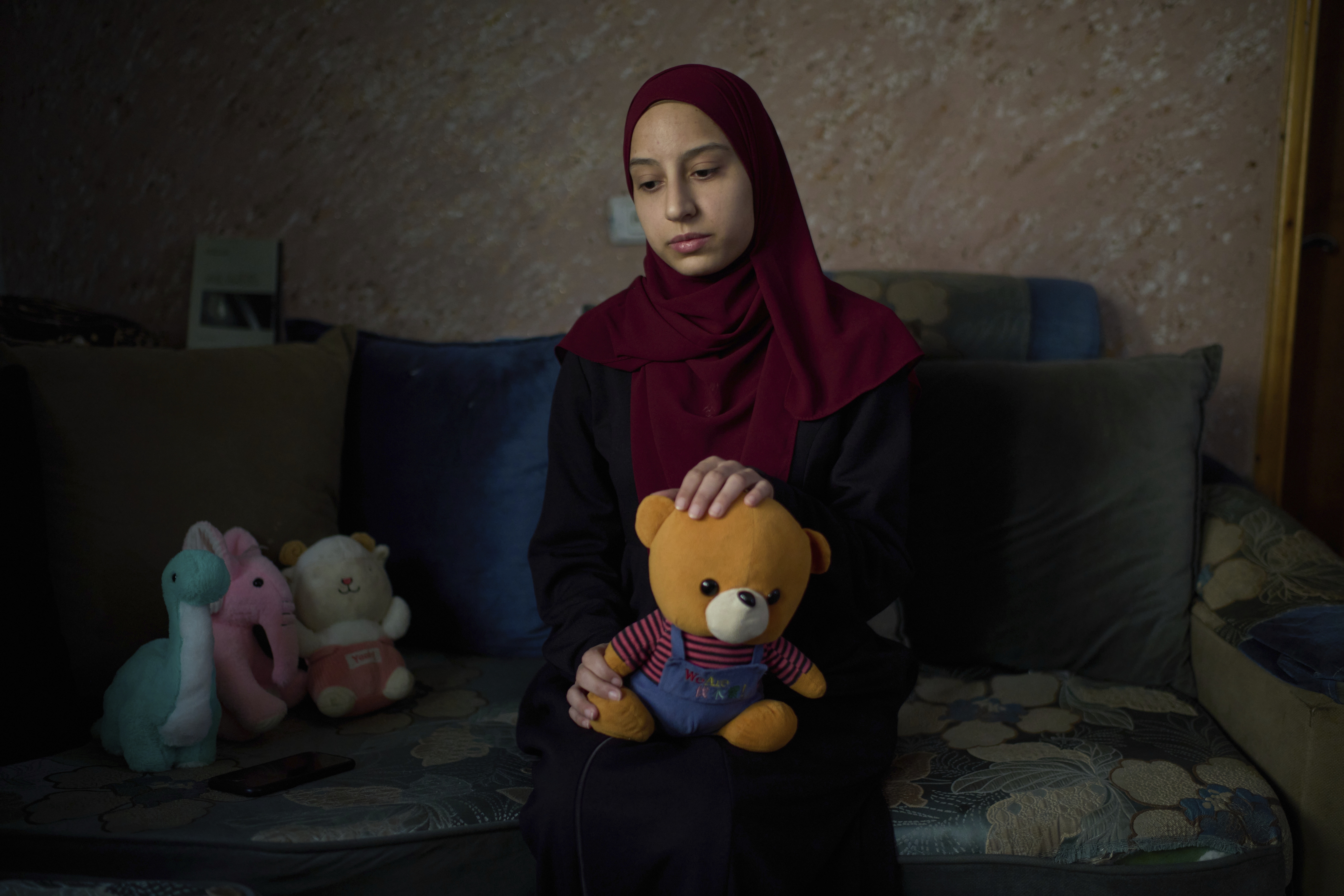 Tayma Asous, 26, holds the favorite toy of her two-year-old daughter, Layla al-Khatib, who was killed by Israeli forces.