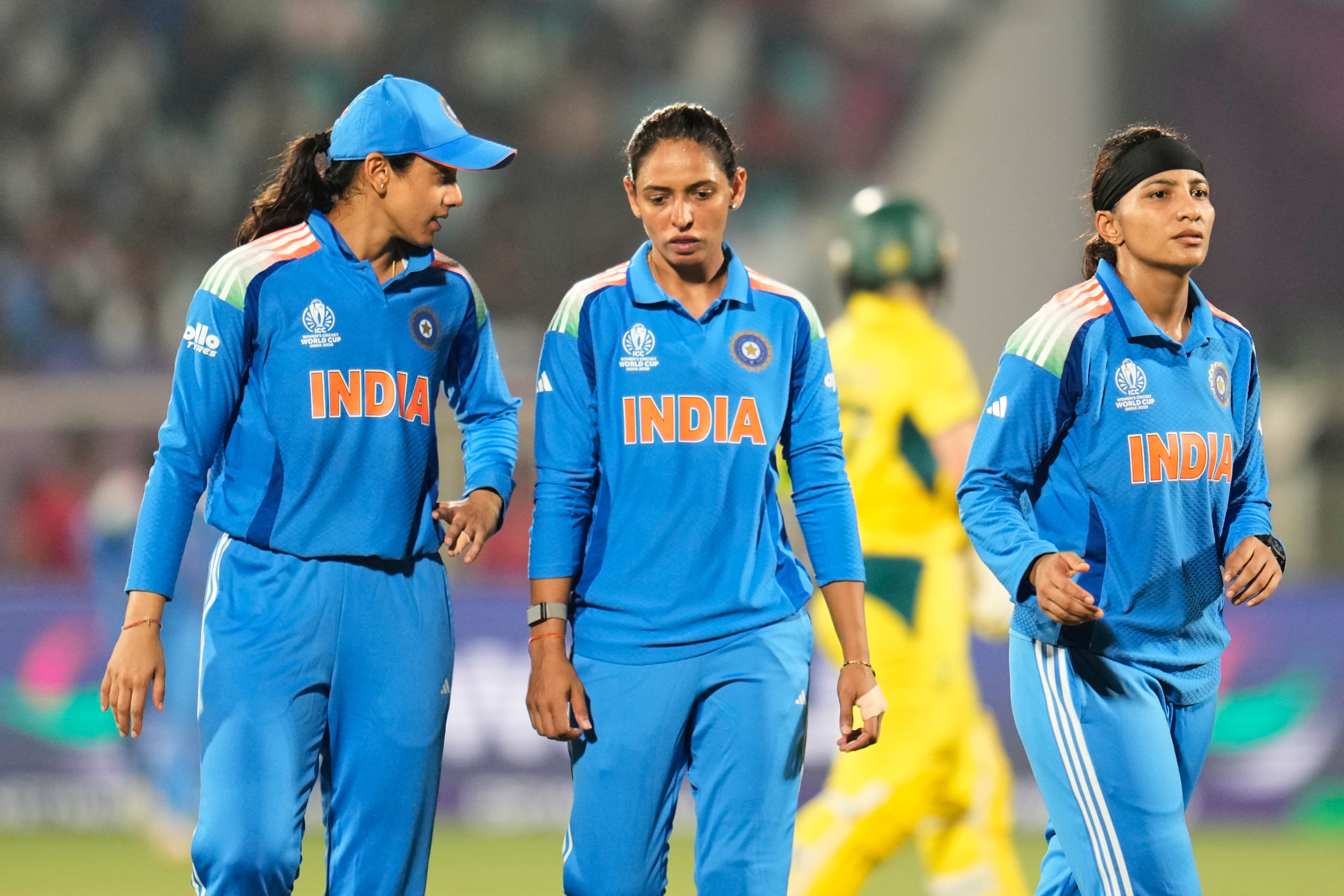 India's captain Harmanpreet Kaur, center, listens to teammate Smriti Mandhana, left, during the drinks break at the ICC Women's Cricket World Cup match between India and Australia at ACA-VDCA Cricket Stadium in Visakhapatnam, India, Sunday, Oct. 12, 2025. (AP Photo/Aijaz Rahi)
