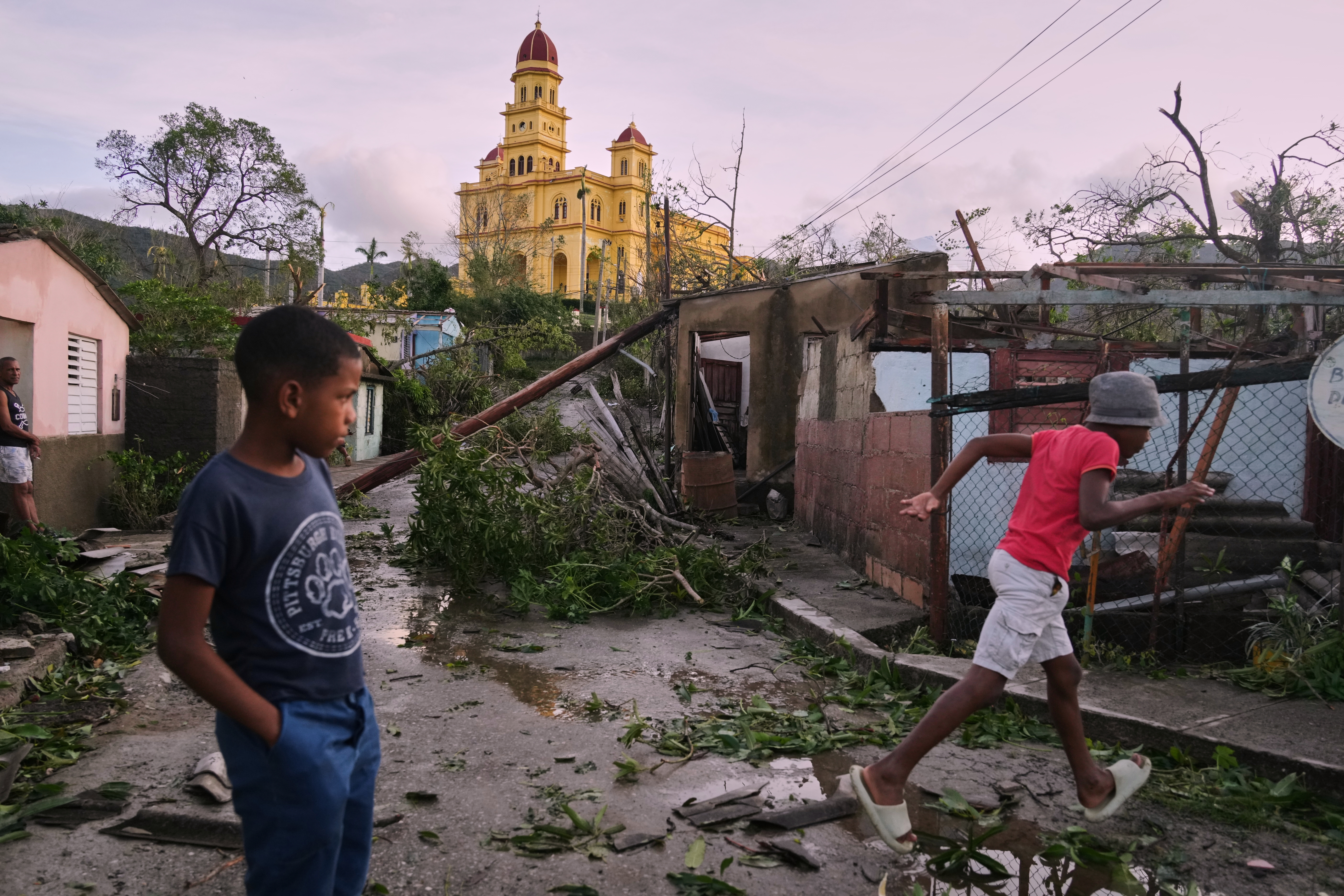Boys walk in El Cobre, Cuba, in the aftermath of Hurricane Melissa on Wednesday, Oct. 29, 2025.